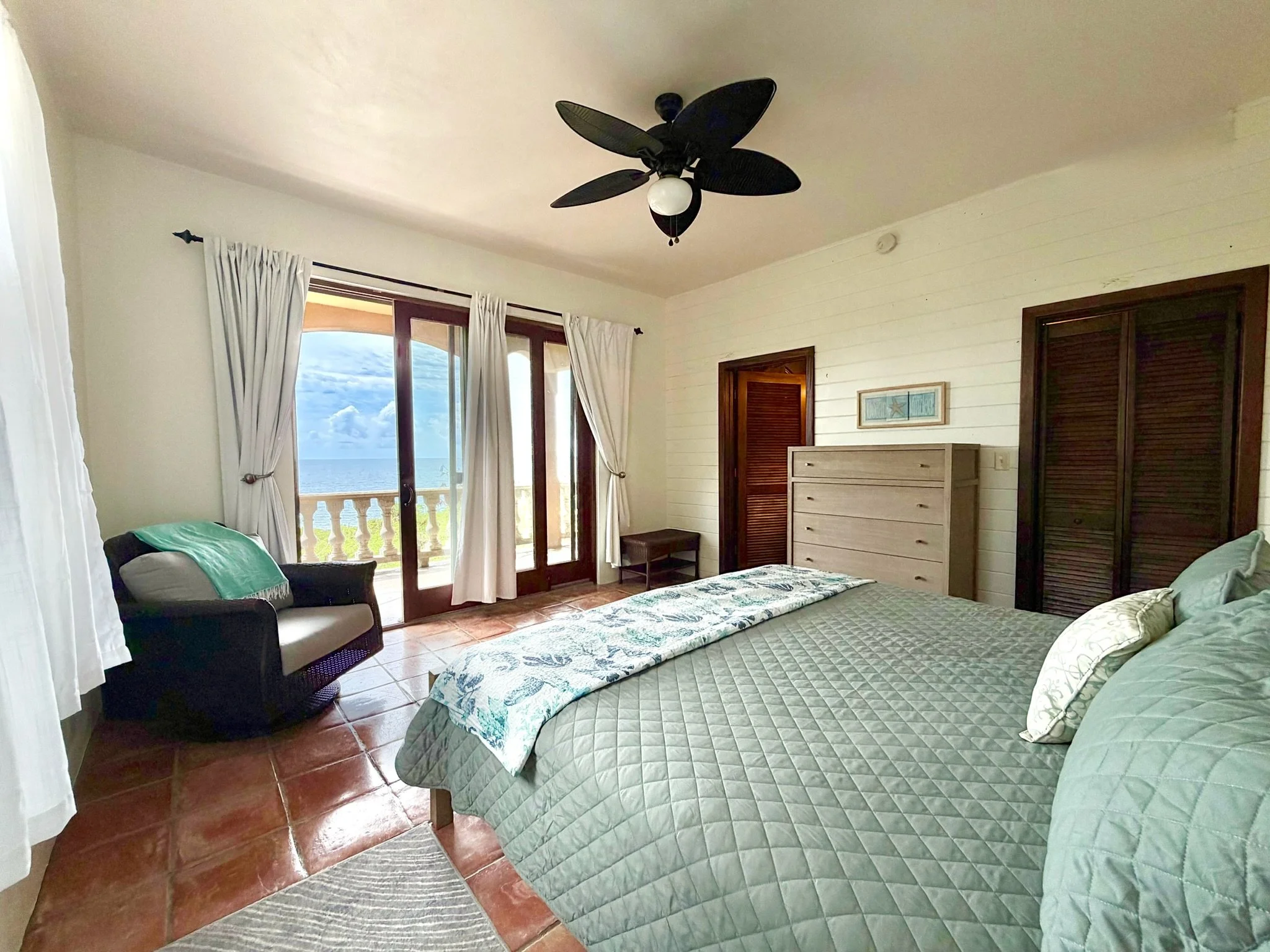 Bedroom 3 with sliding glass door, view, ensuite bathroom, and clothes storage