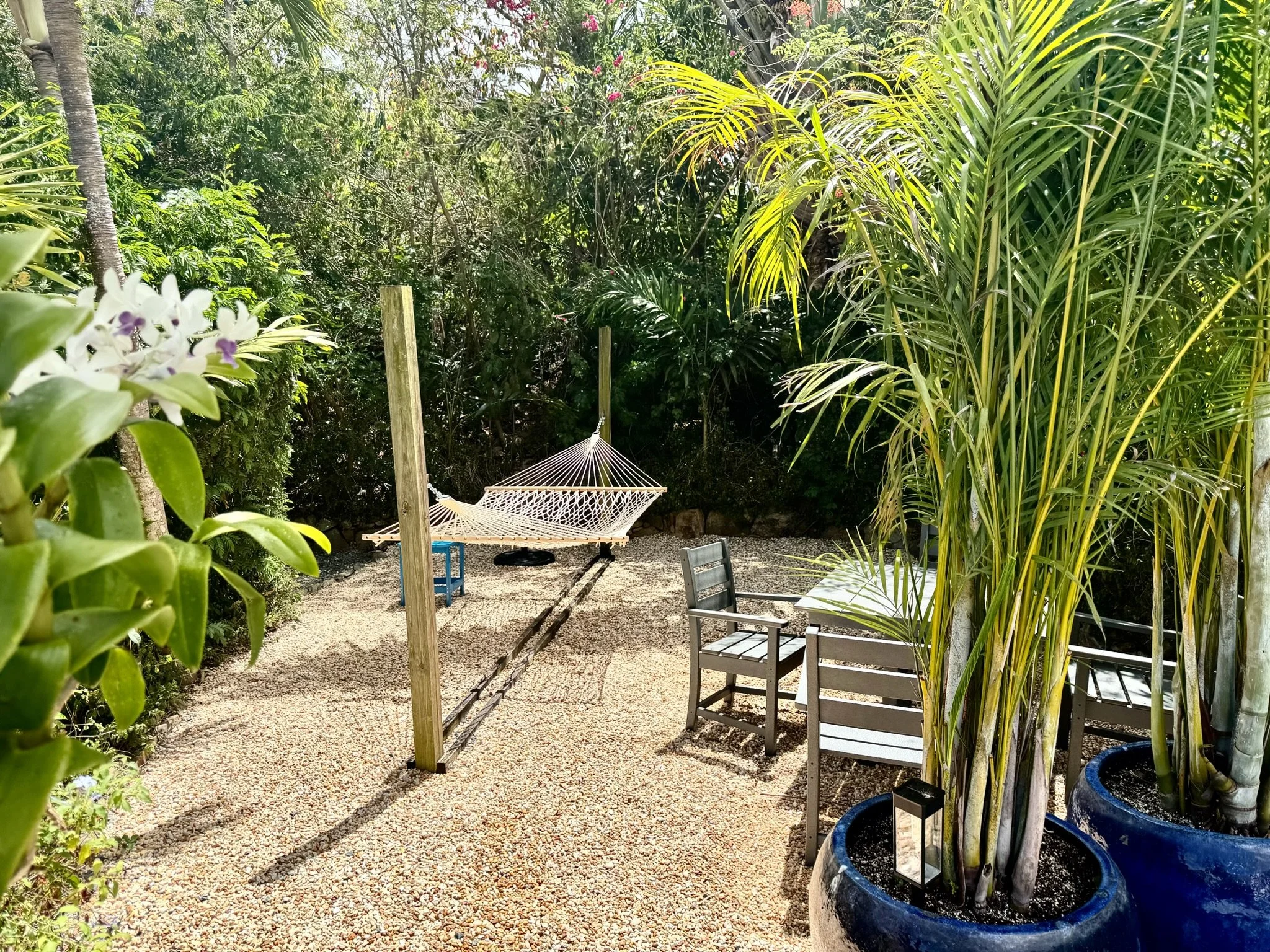 Covered by swaying palms, this outdoor gathering space is perfect for dining, relaxing, and enjoying island life