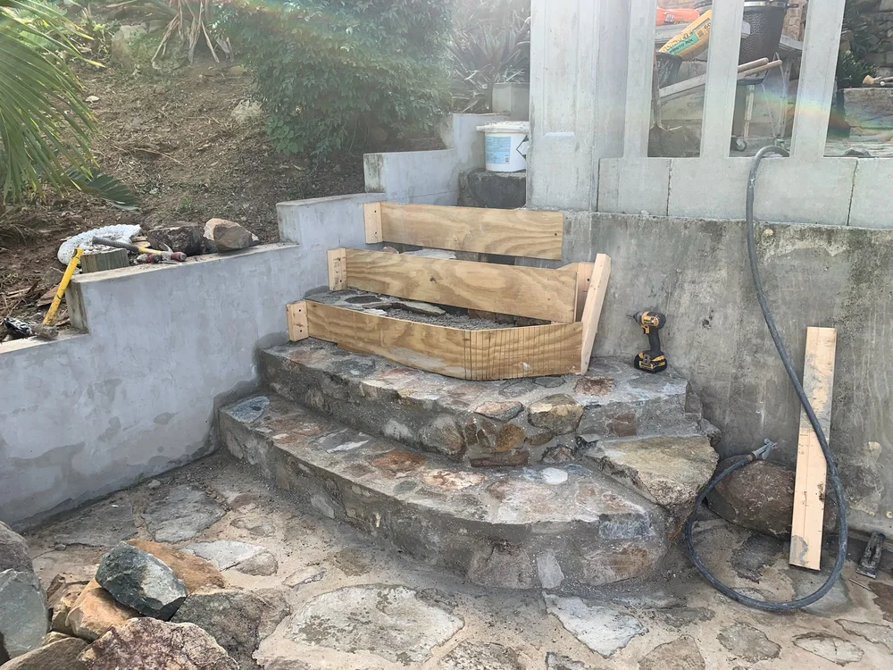 Stone steps being built beside the pool at Stone Falls