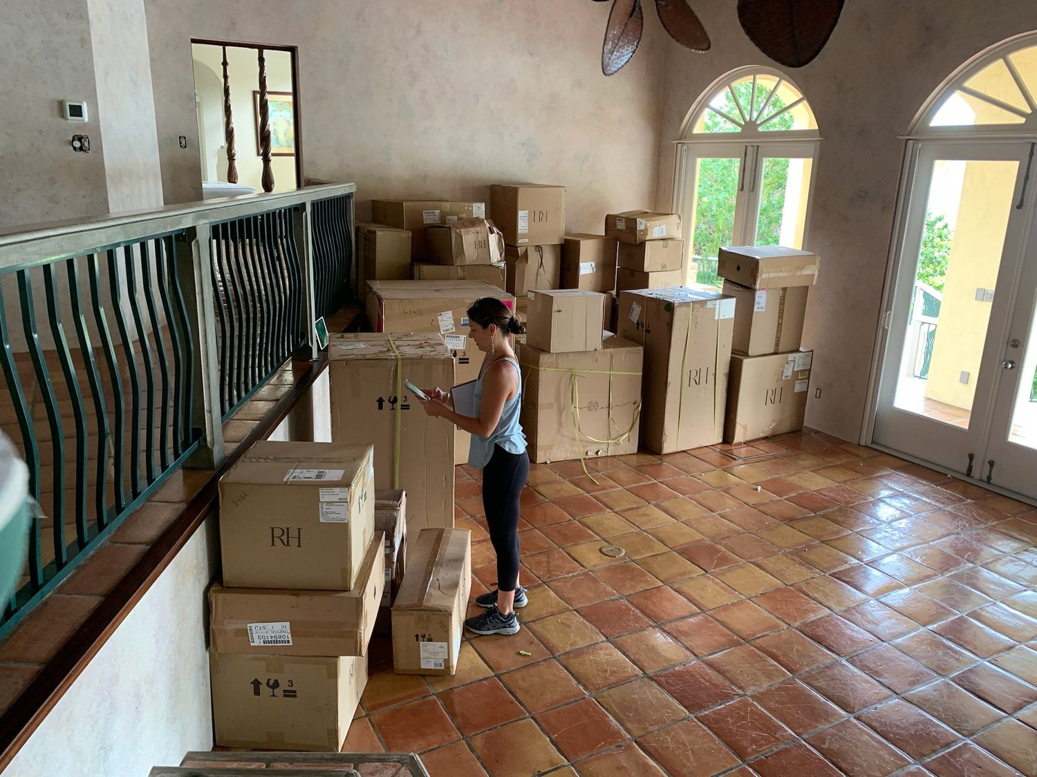 Angie counting and organizing furniture boxes during the 2B Peter Bay installation