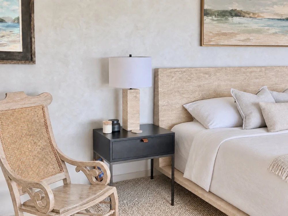 Bedroom layered with carved wood, woven cane, linen and black accents