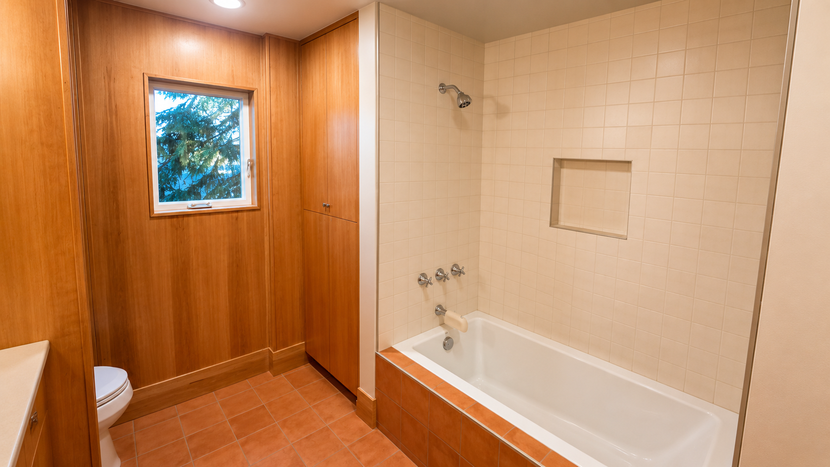 Full bathroom with bathtub and custom tile finishes in a basement conversion project.