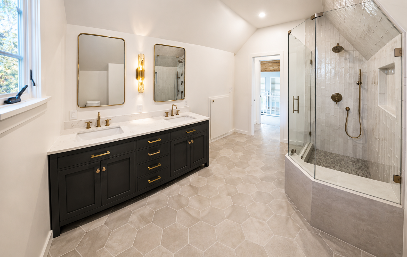 Luxury primary bathroom remodel in Northeast Portland featuring a custom double vanity, walk-in shower, custom tile flooring, and modern brass fixtures.