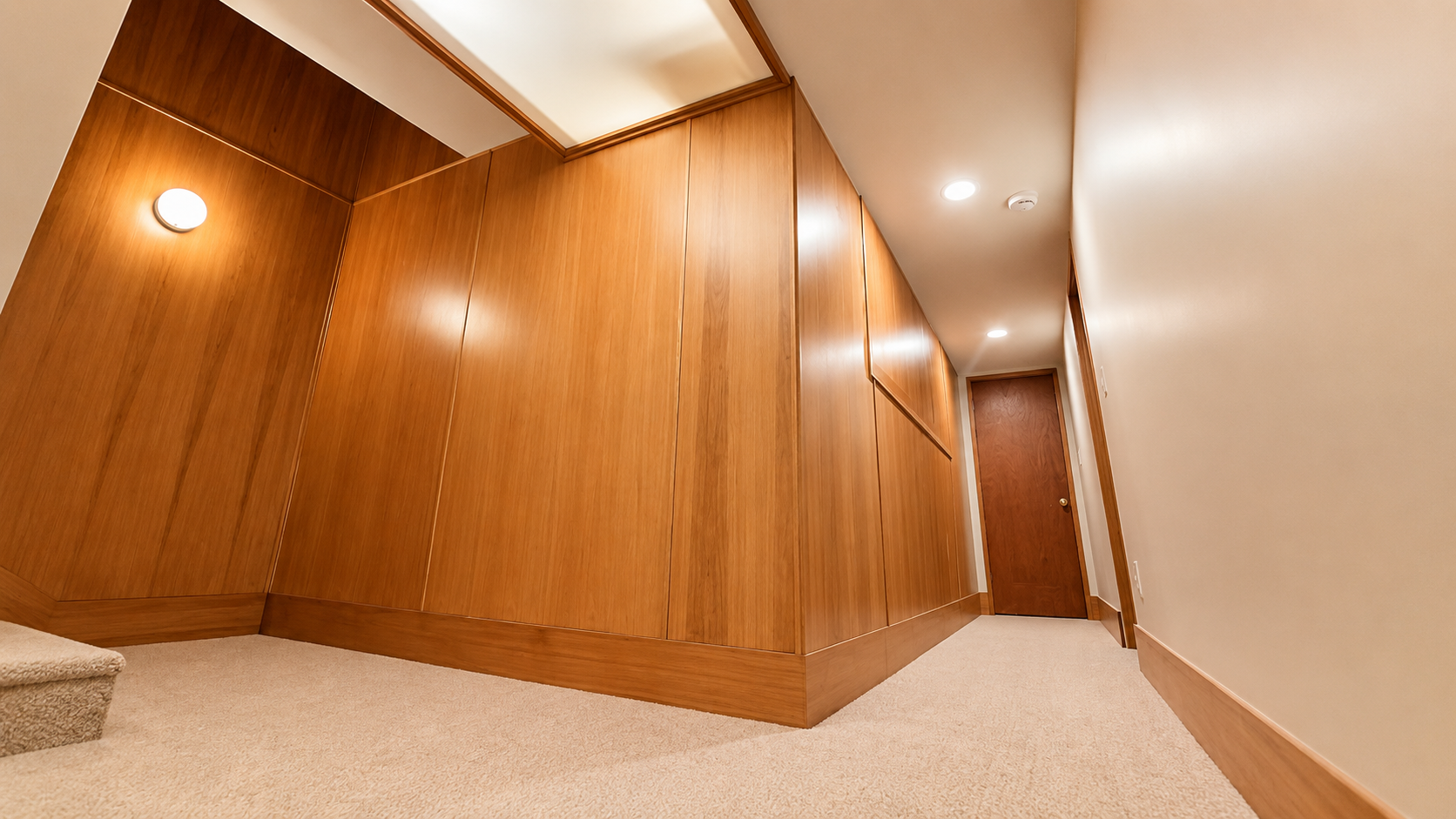 Custom wood-paneled hallway showcasing premium finish carpentry and craftsmanship.