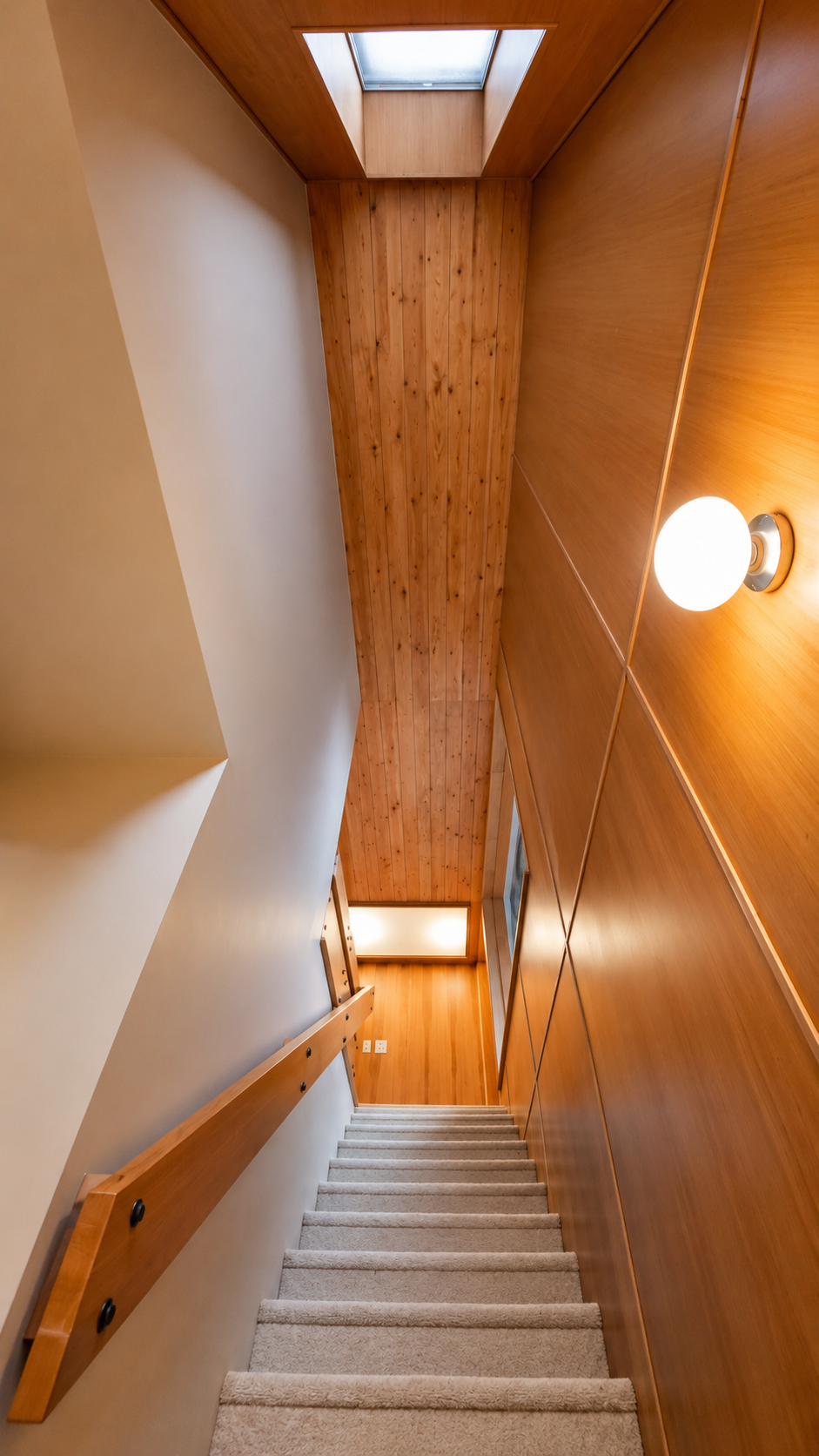 Architectural wood staircase and custom millwork in a basement ADU conversion.