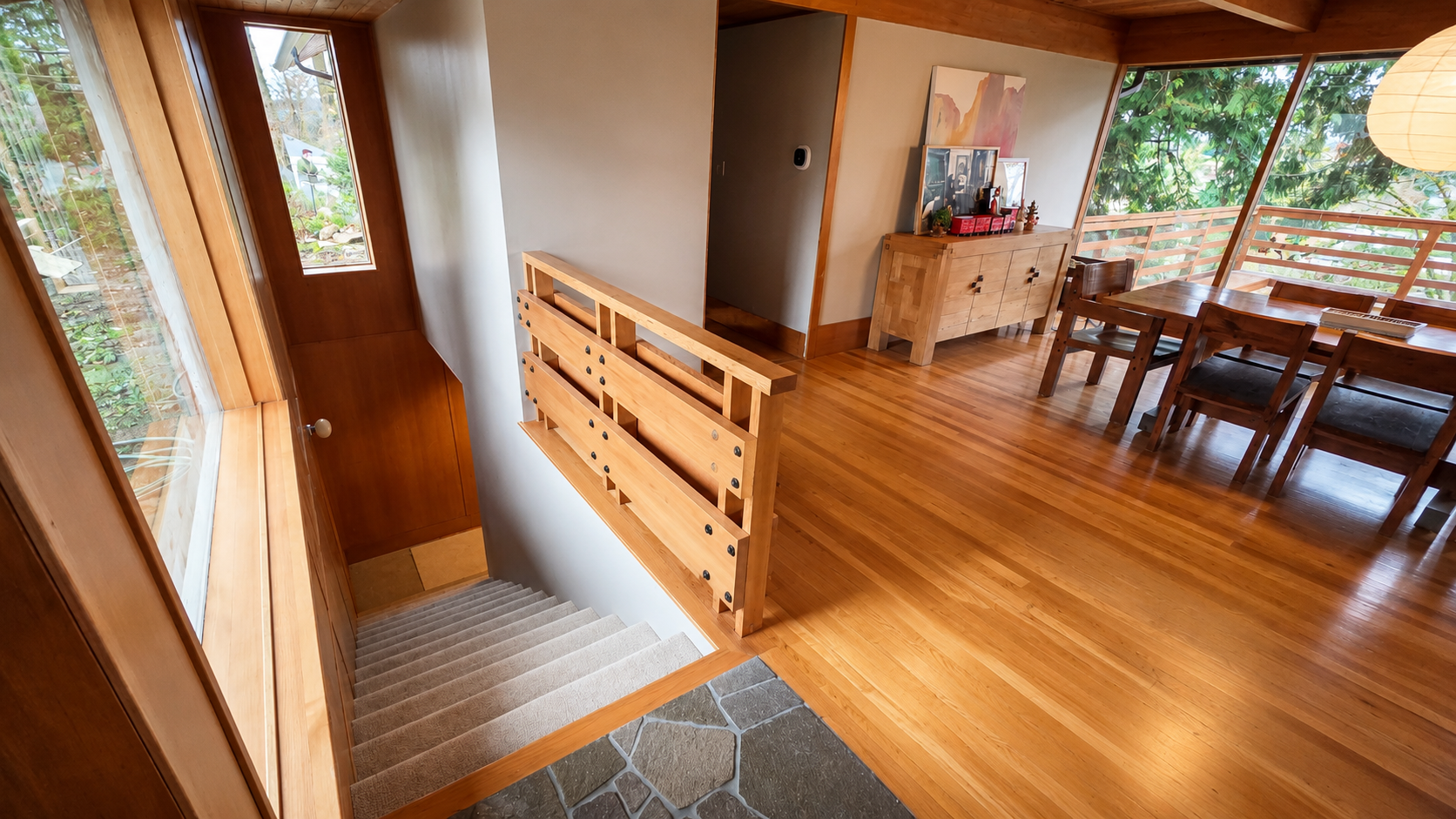 Custom entry landing with architectural wood detailing in a basement ADU conversion.