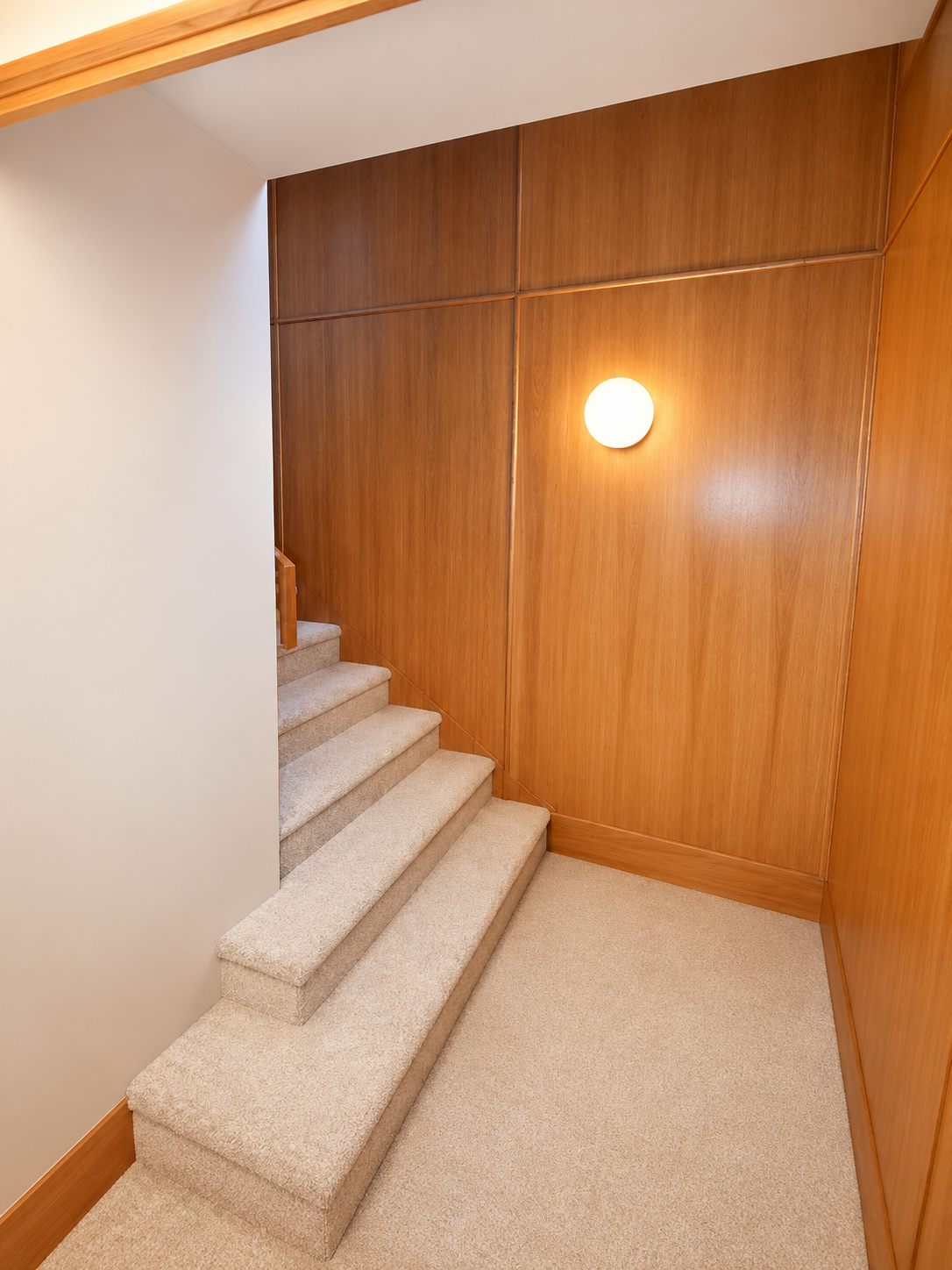 Architectural wood staircase and custom millwork in a basement ADU conversion.
