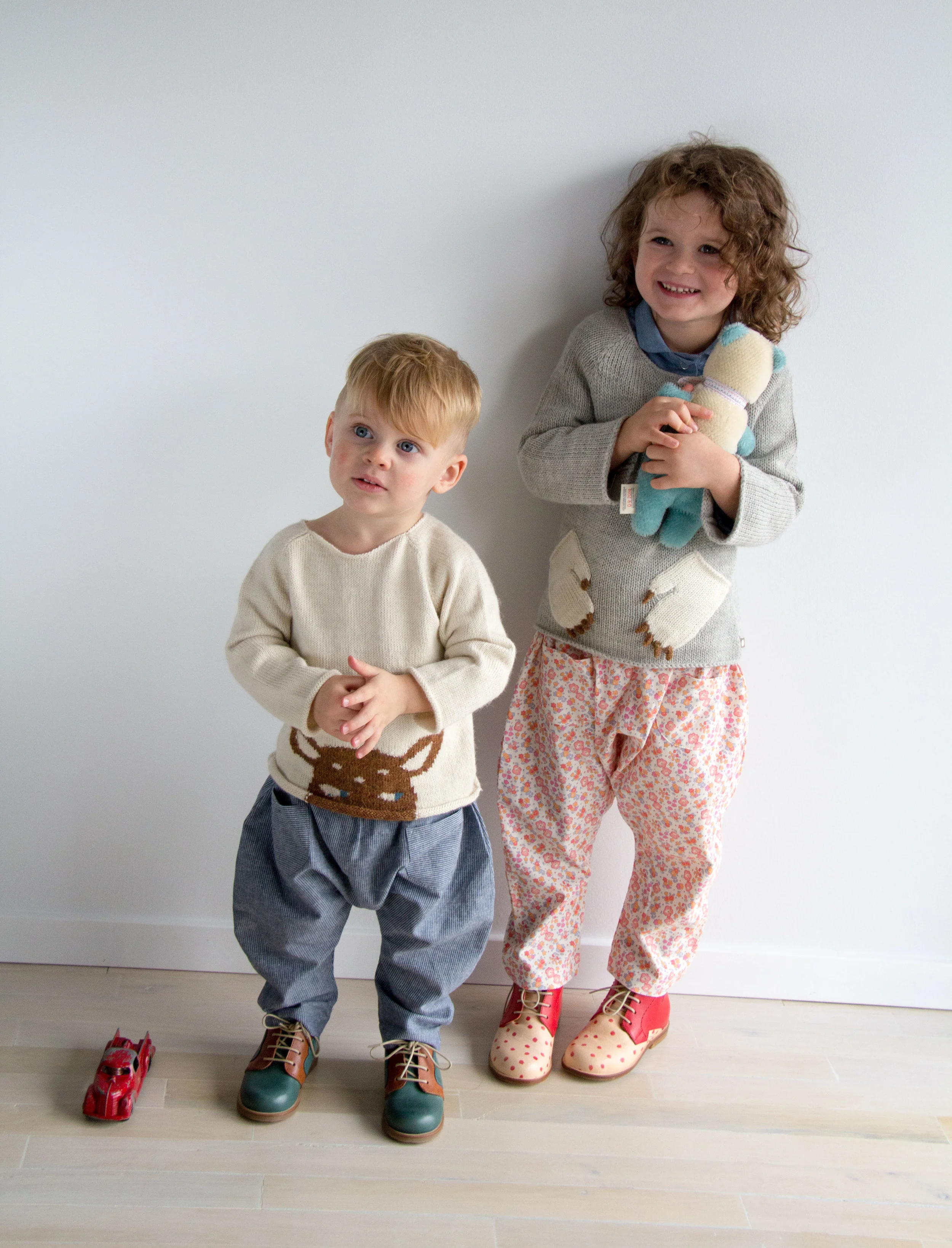 On Eloise: Nathalie Verlinden 'Mingus" Booties | Soor Ploom Harem Pants | Misha and Puff Visor Bonnet | Red Creek Handmade chambray work shirt (available mid-November) | Oeuf NYC Hug Me Monster Sweater | Polka Dot Club Bear On Levi: Nathalie Verlinden 'Billy' Booties | Soor Ploom Harem Pants | Oeuf NYC Peeking Bambi Sweater