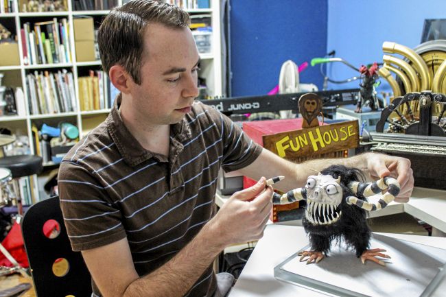 Josh Funk, a Chico director and writer, demonstrates how his puppet will be used in creating his live action and stop-motion film, "The Spaceman." (Leila Rodriguez —Enterprise-Record)