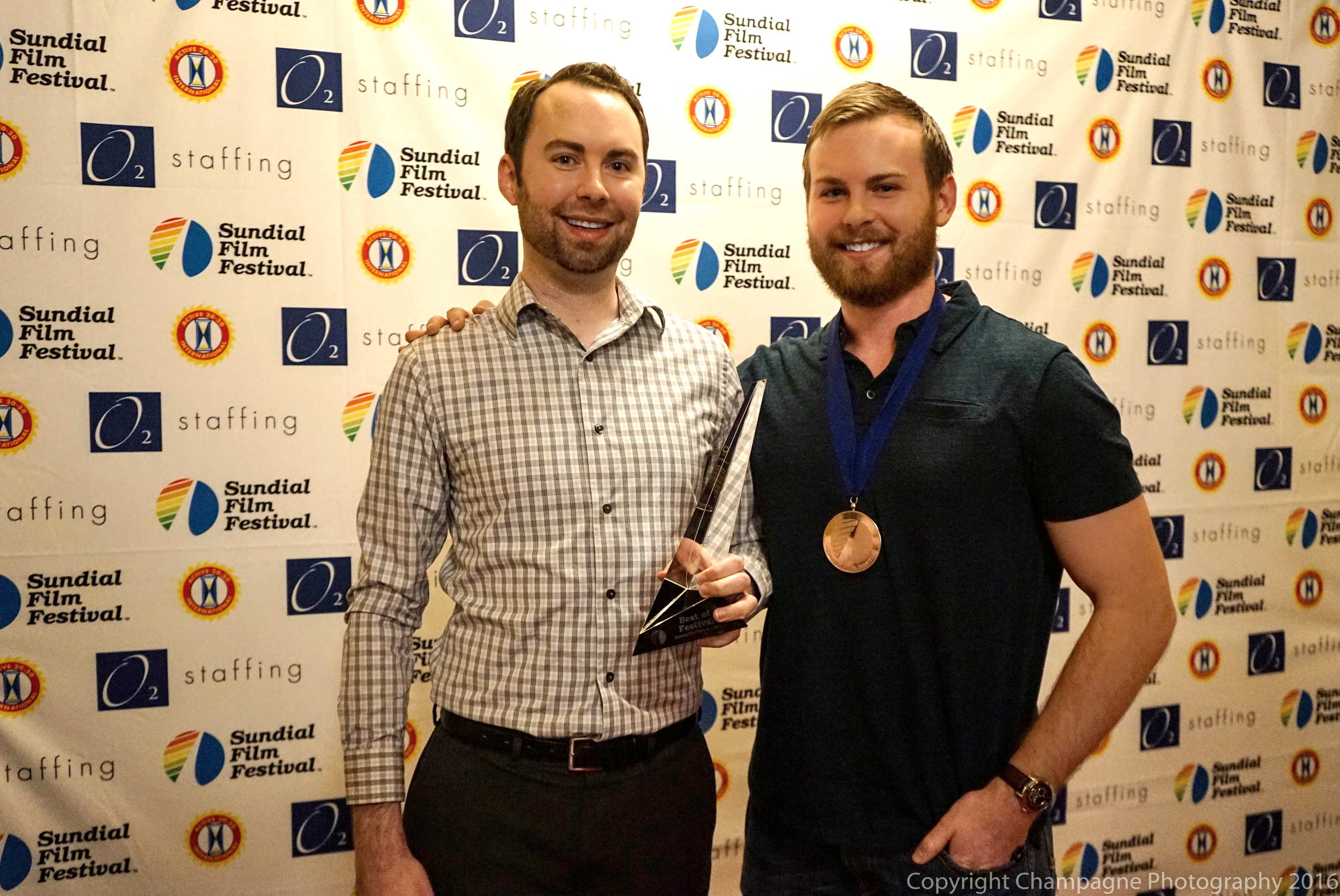 Josh Funk and his brother Jordan Funk with awards for The Spaceman.
