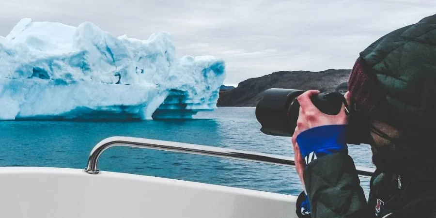 Daniel masters the art of shooting icebergs with cold, numb fingers. Photo: Abi Whyte