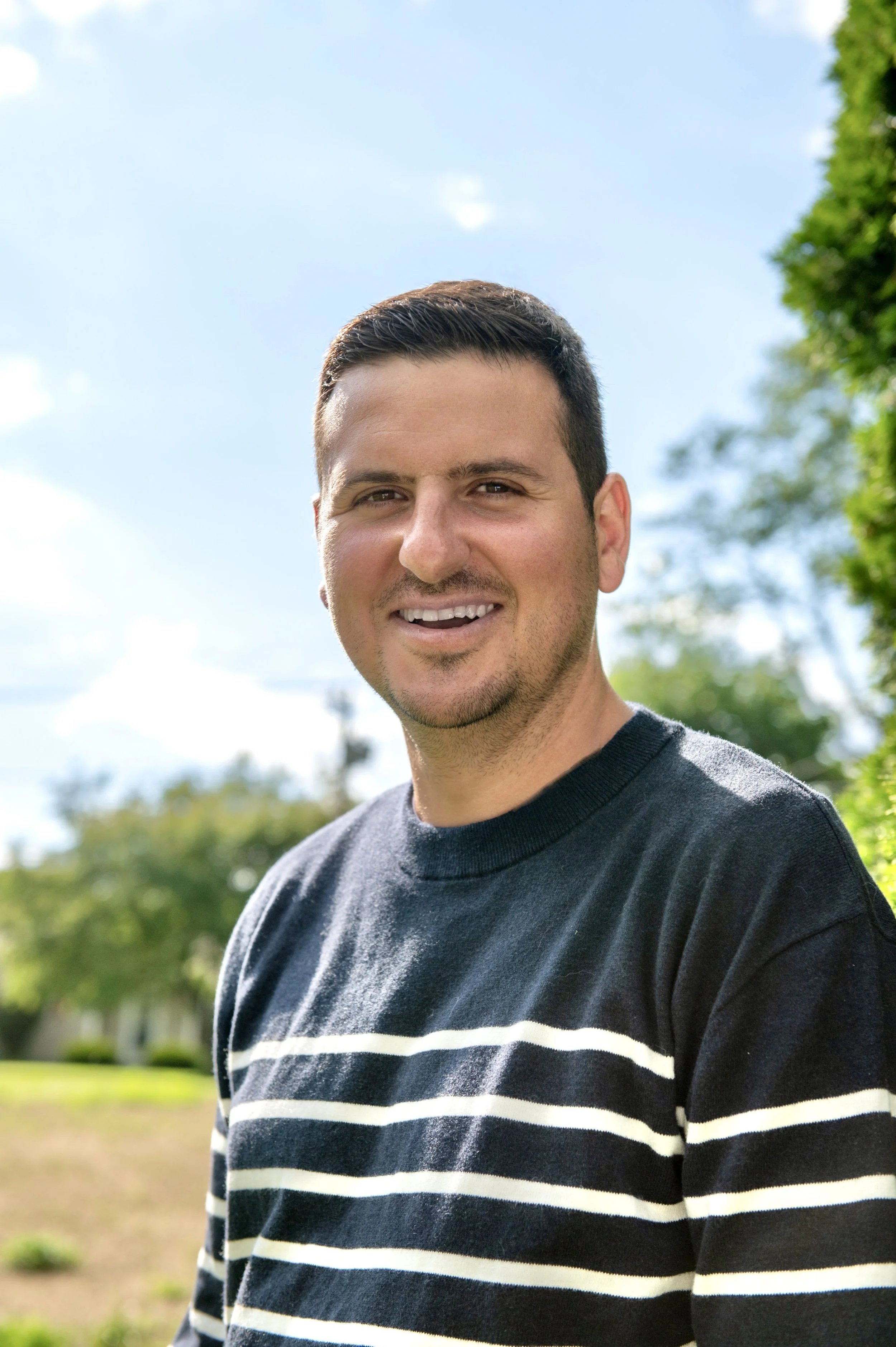Nick Mancuso smiling against blue sky