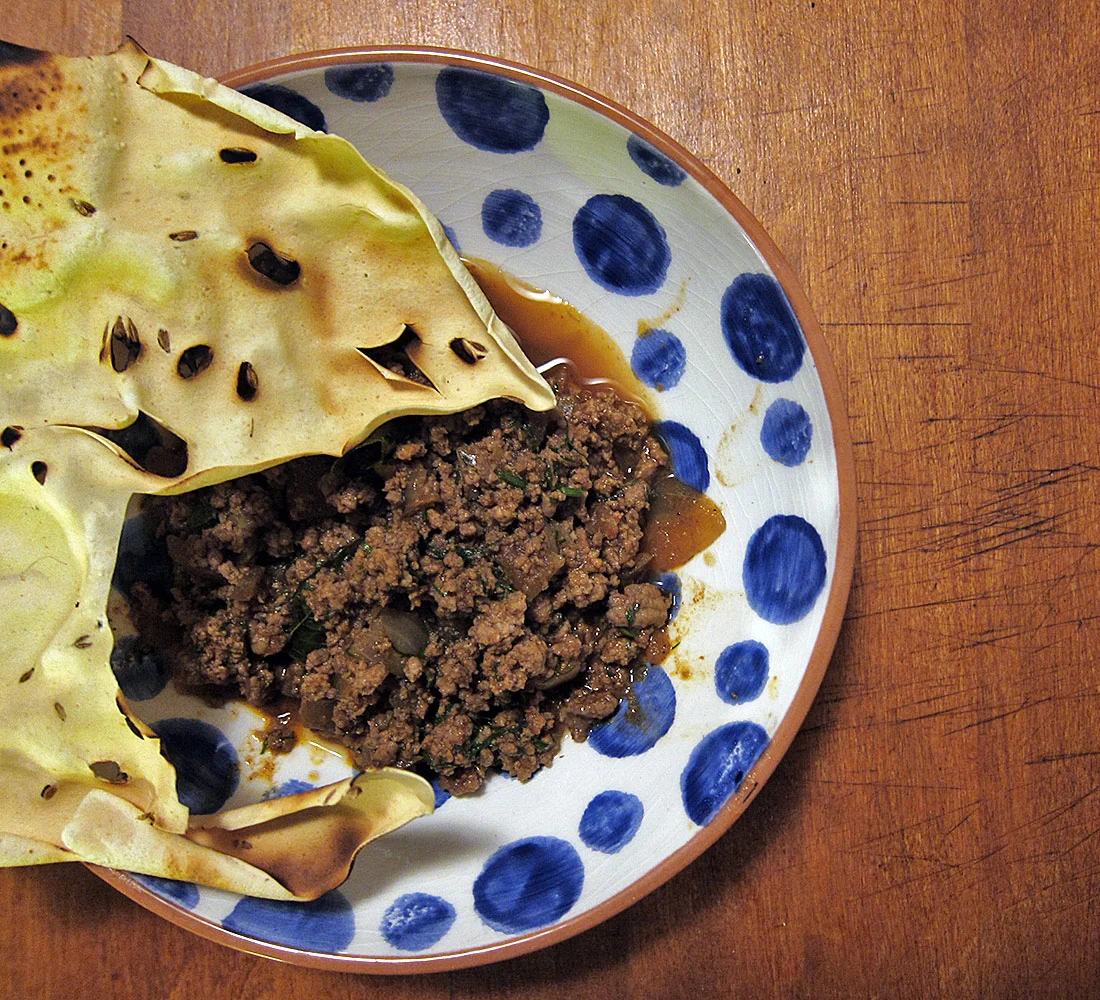 A papad, if you have any, is a great edible scoop
