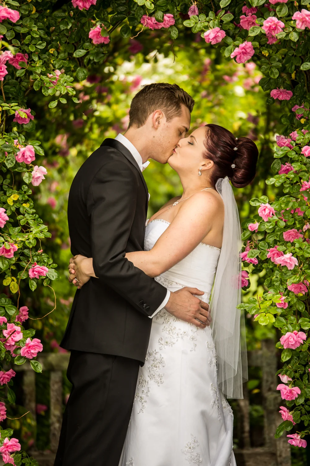 Bride and Groom under the roses.