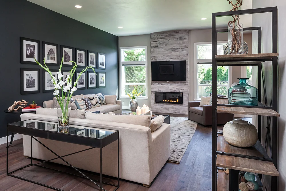 Living room with black-and-white photographs and a stone fireplace wall