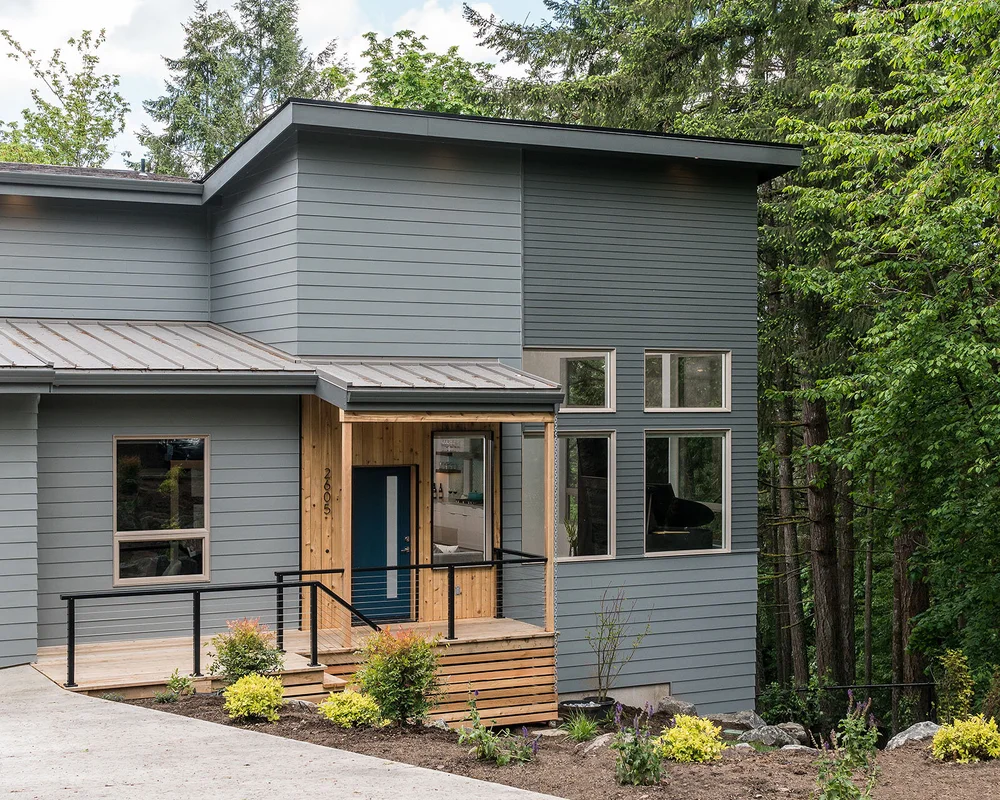 Hendricks Park Hillside Home exterior with gray siding and a covered entry