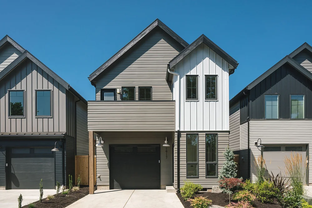 Row of new homes with mixed gray and white siding
