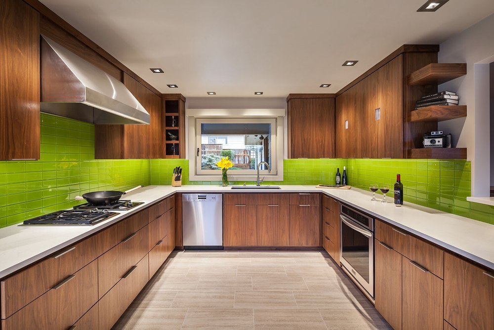Walnut kitchen with a bright green glass backsplash