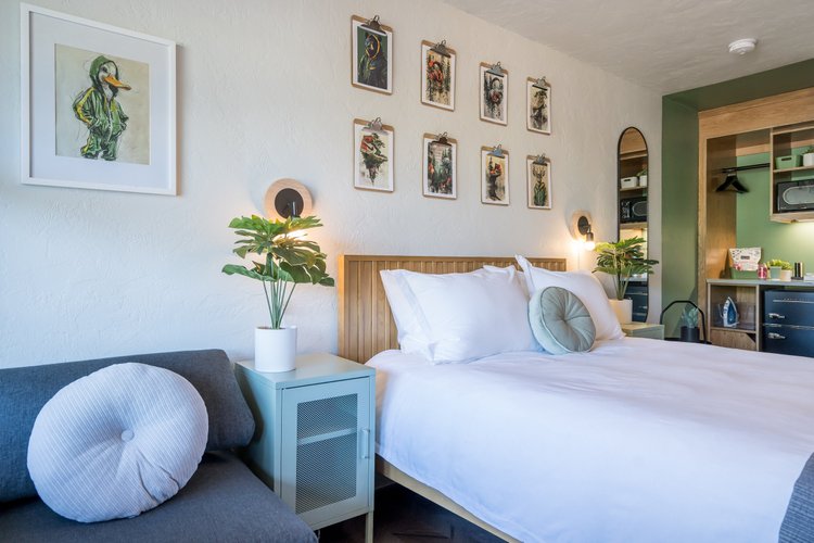 Guest room at The Local with a white oak bed and Pacific Northwest artwork