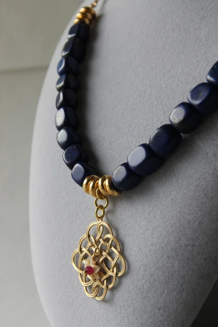 Midnight in the Garden (lapis lazuli, ruby, handcarved shell, gold plated brass, brass)