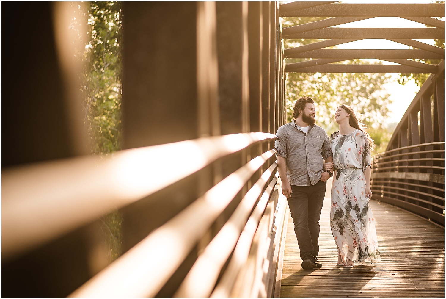  A couple walking down a bridge at a Michigan state park.  