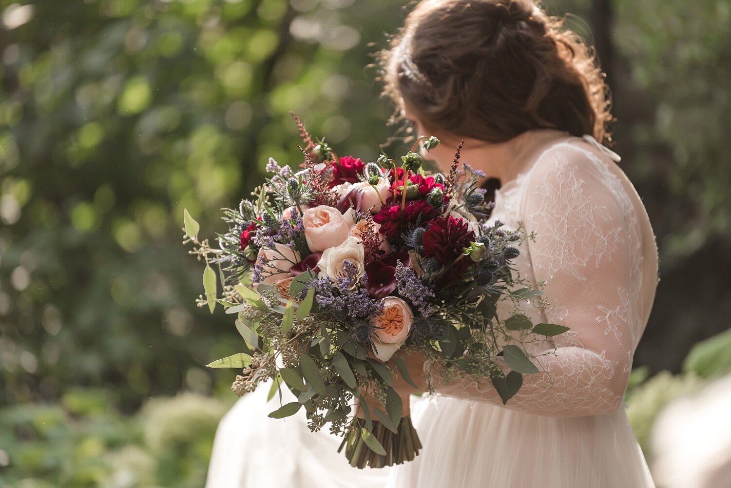  A blush and dark red bouquet being held by a Detroit bride.  