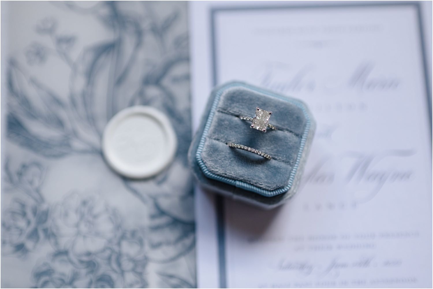  A close-up of wedding rings in a blue velvet box.  