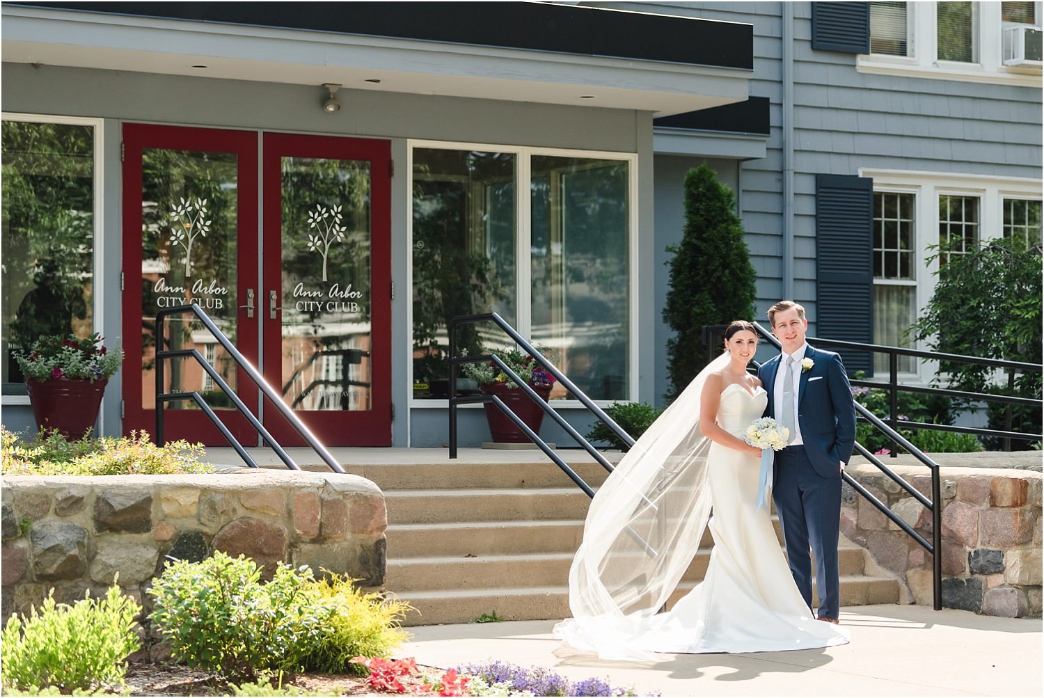  A newly married couple stands in front of the doors at the City Club in Ann Arbor.  