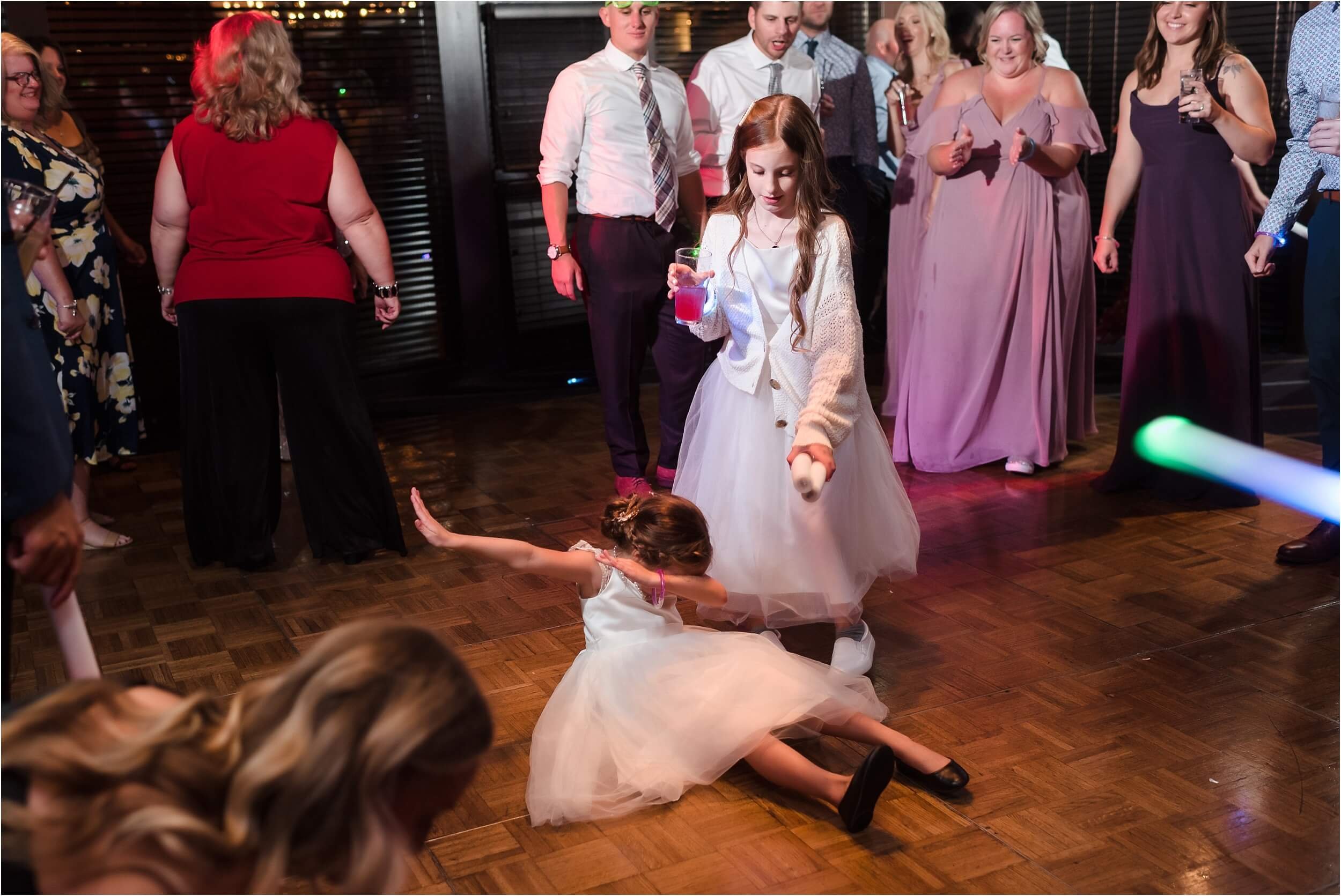  A little girl dabs on the dancefloor of a lively wedding reception.  