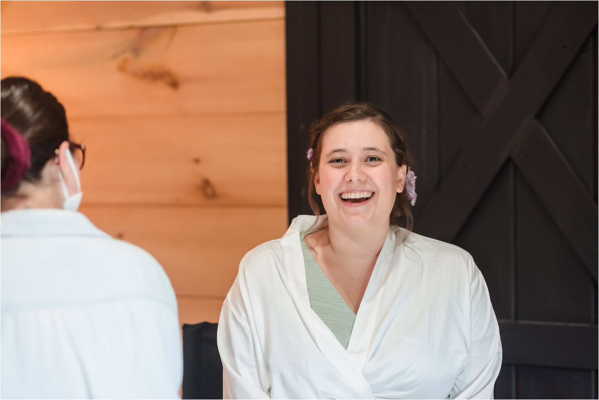  A brunette bride laughs while getting her make-up done.  