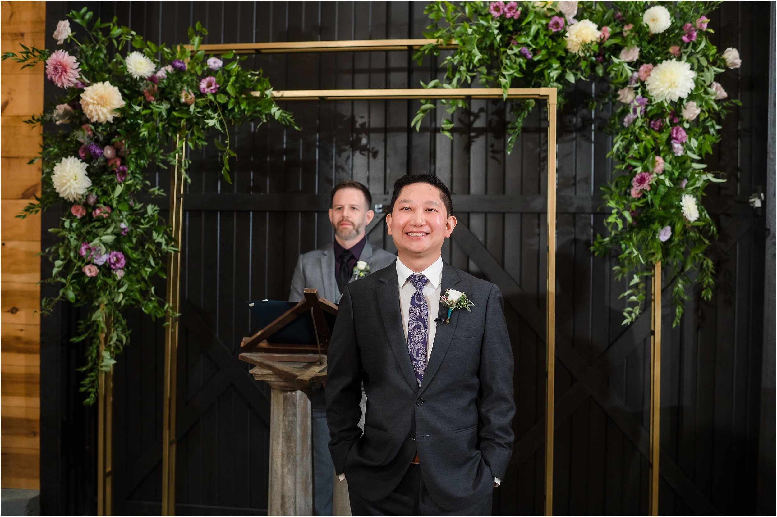  A groom smiles at his fiance as she walks down the aisle with her brother.  