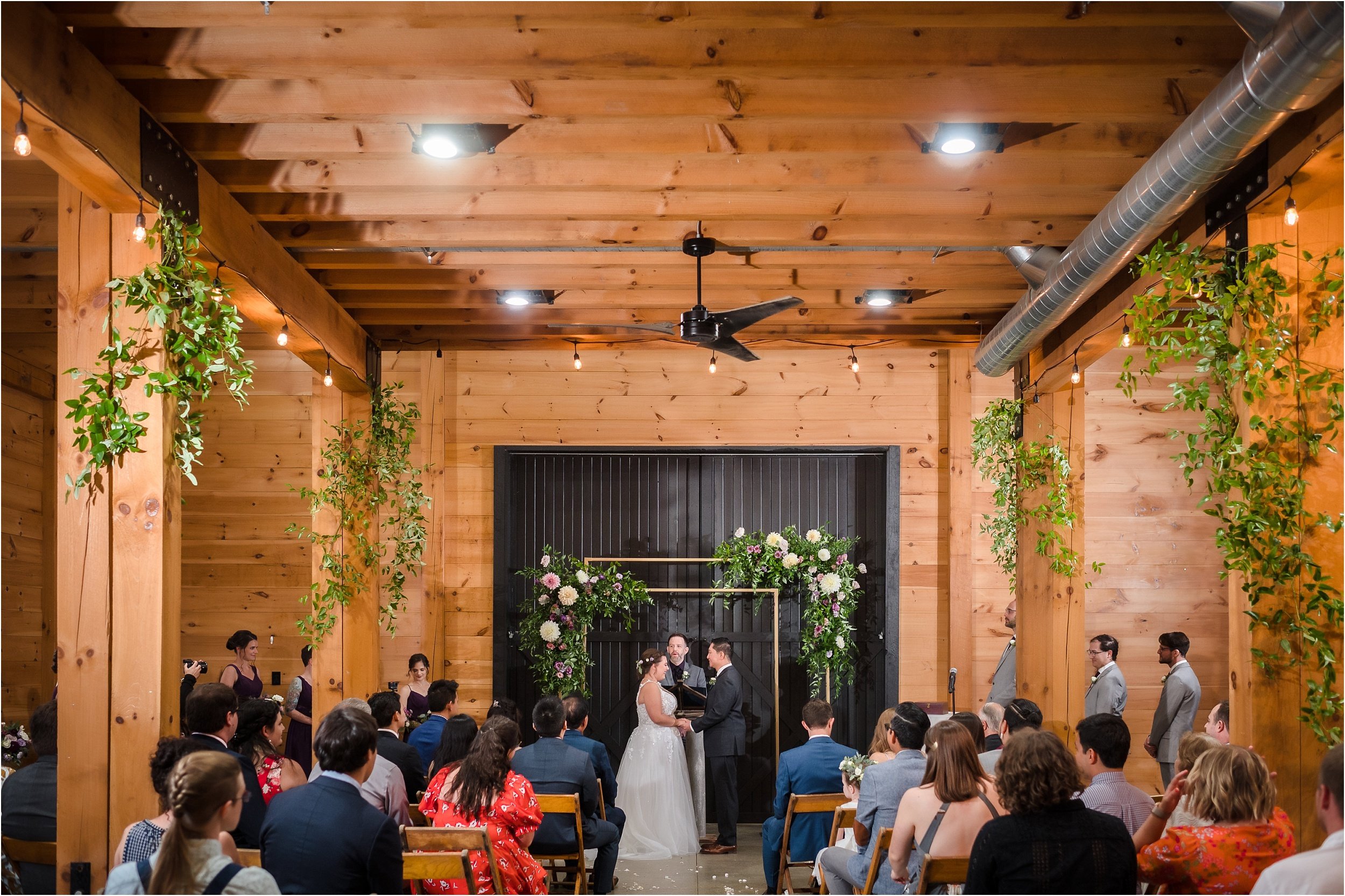  A wide perspective of a ceremony inside a barn venue in Chelsea, Michigan.  