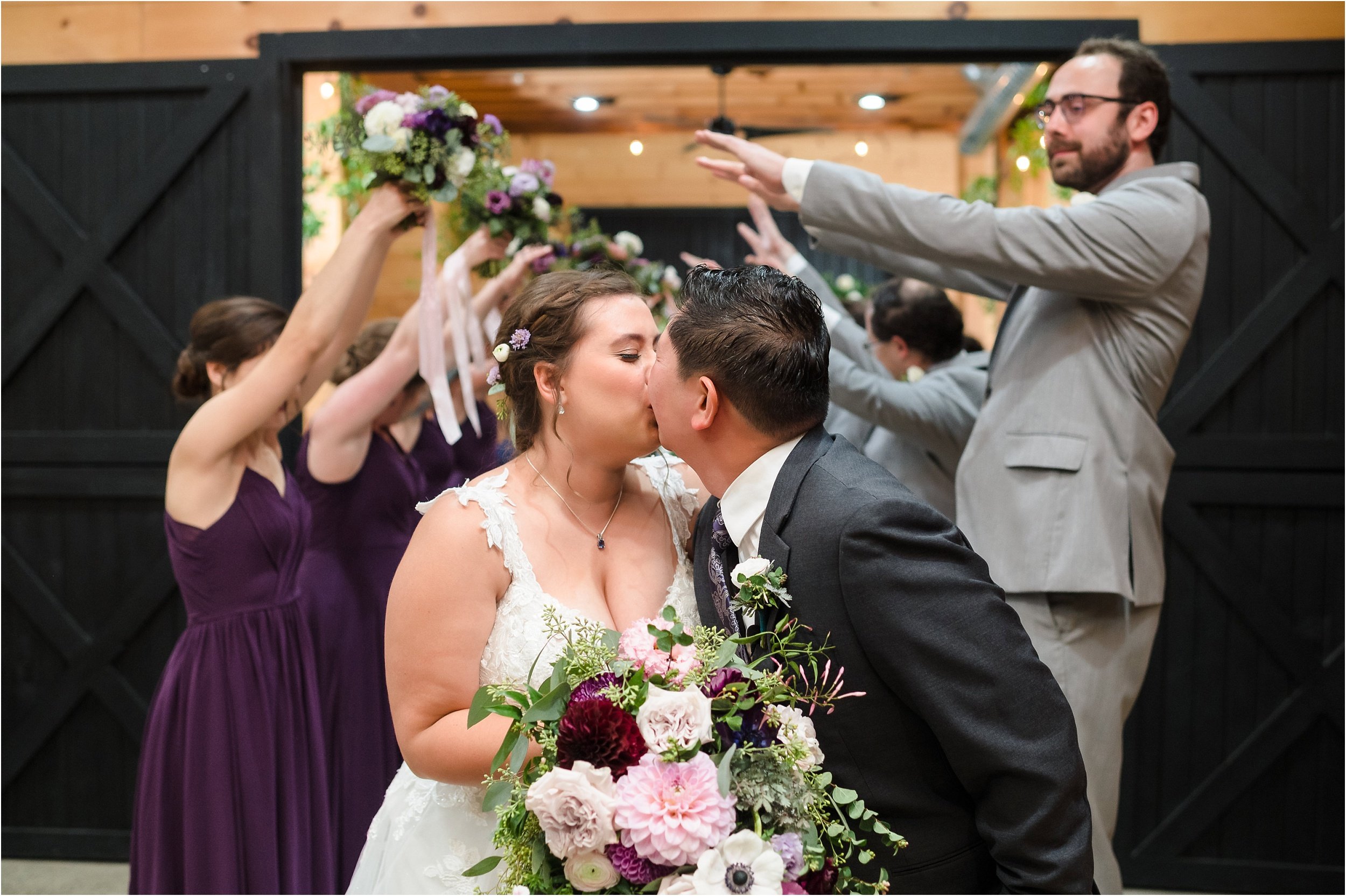  A couple shares a kiss after recessing down the aisle of their ceremony.  