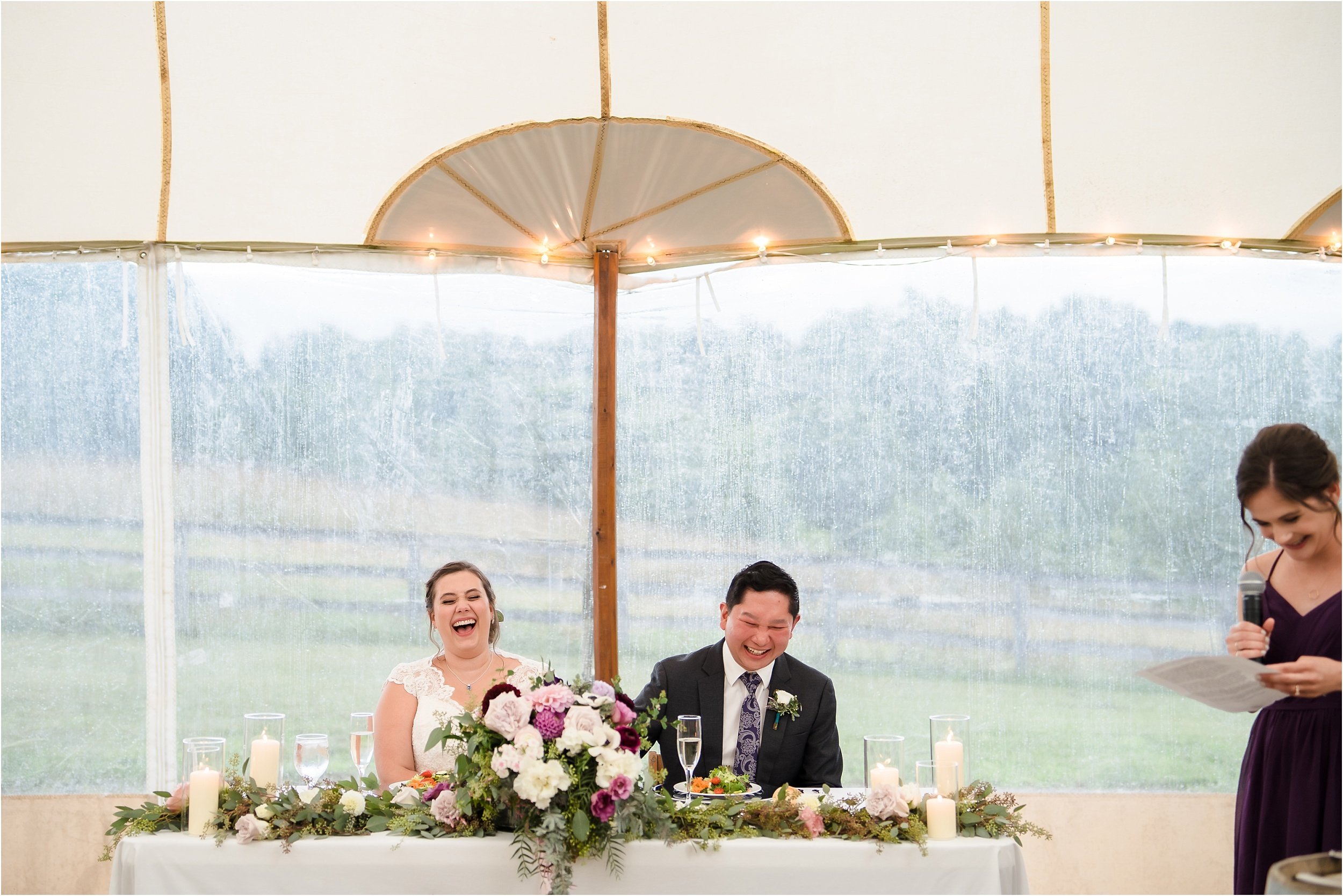  A bride laughs loudly at her friend’s speech.  