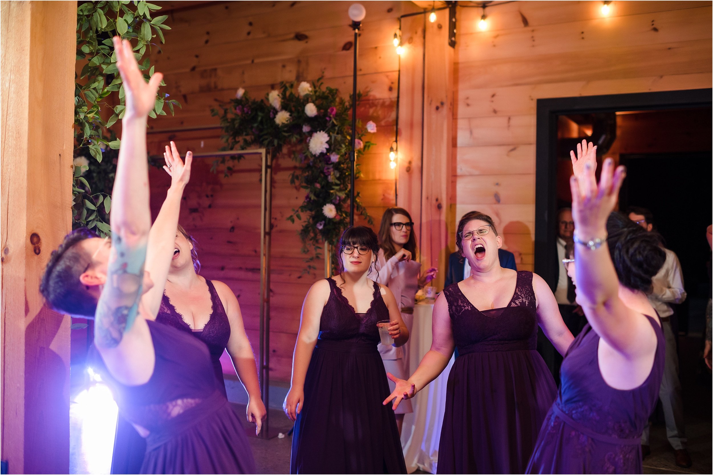  Bridesmaids singing along to a popular song during the dance party at a wedding.  