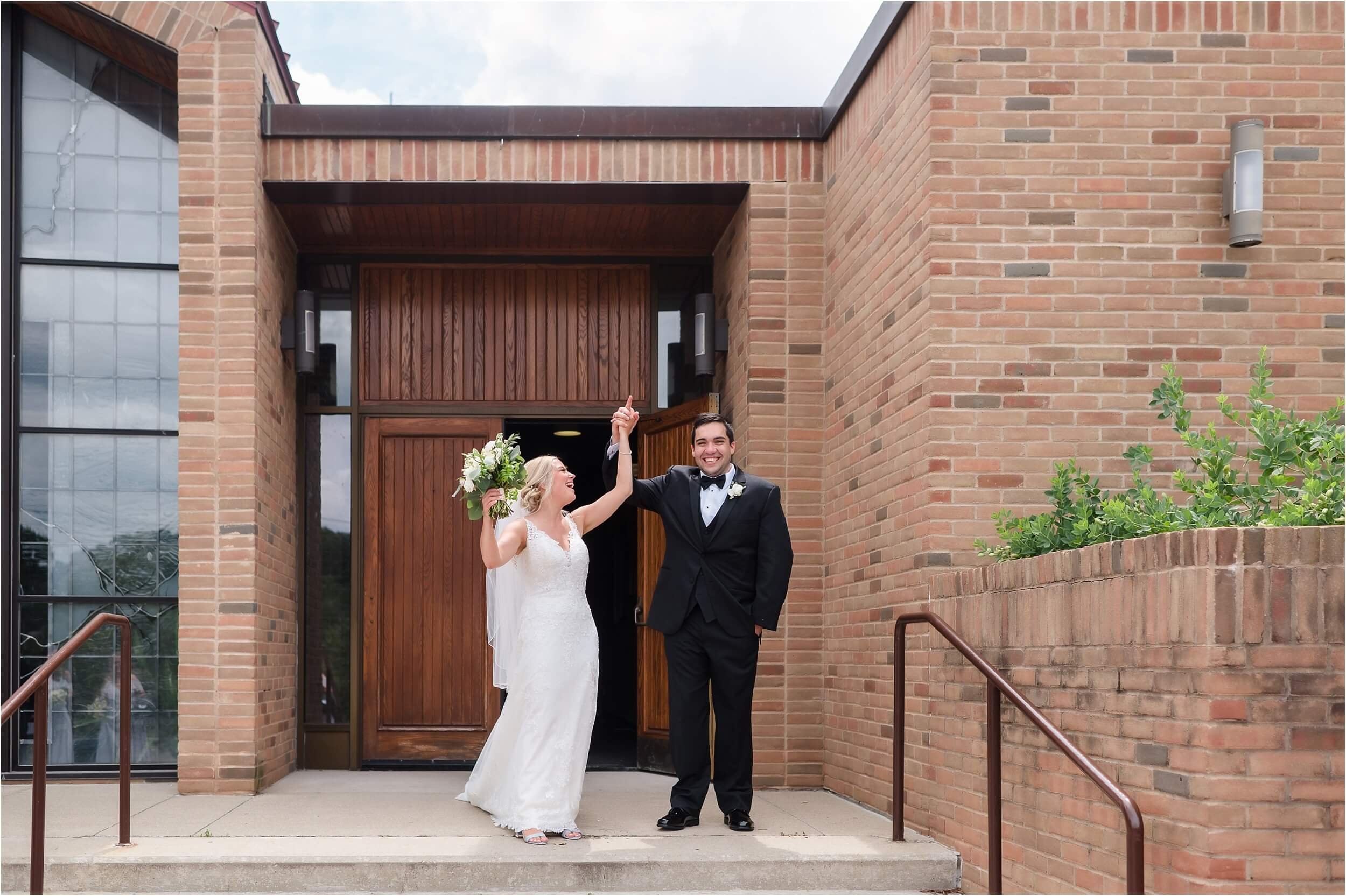  A couple excitedly leaves after their wedding at St Francis of Assisi church in Washtenaw county.  