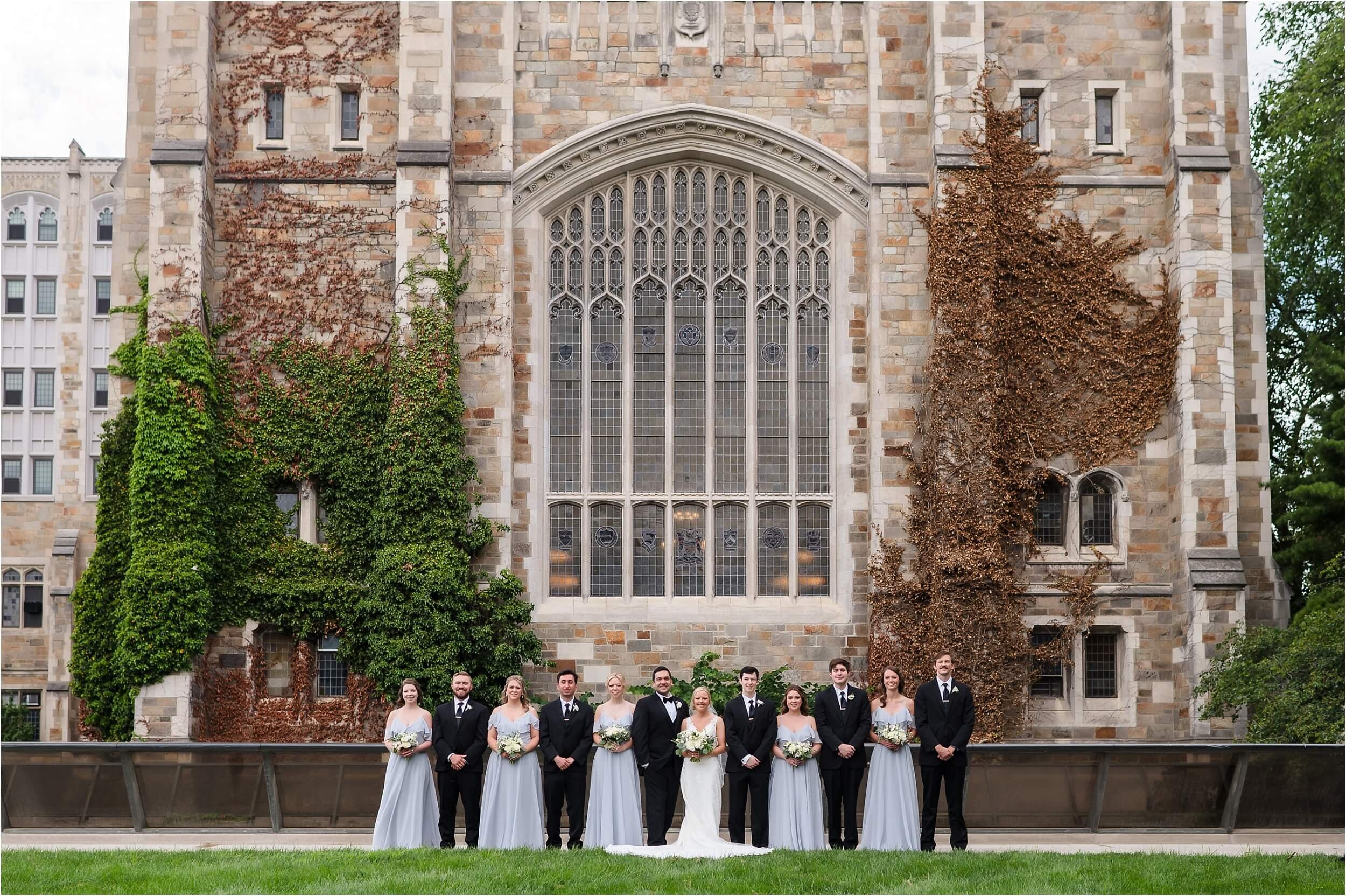  A wedding party stands in front of the University of Michigan Law Library on a summer day.  