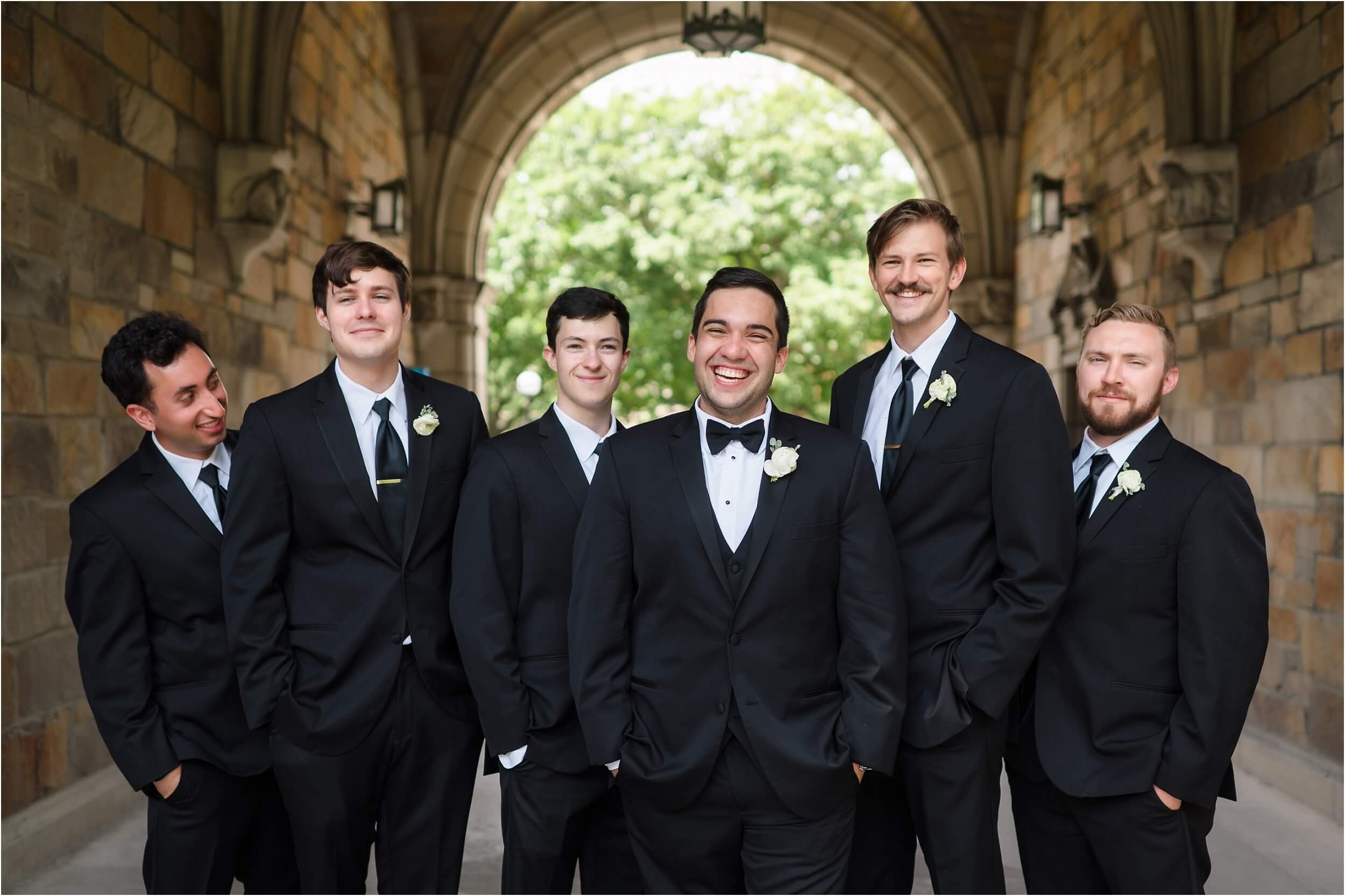  A groom laughs during his portraits after his wedding.  