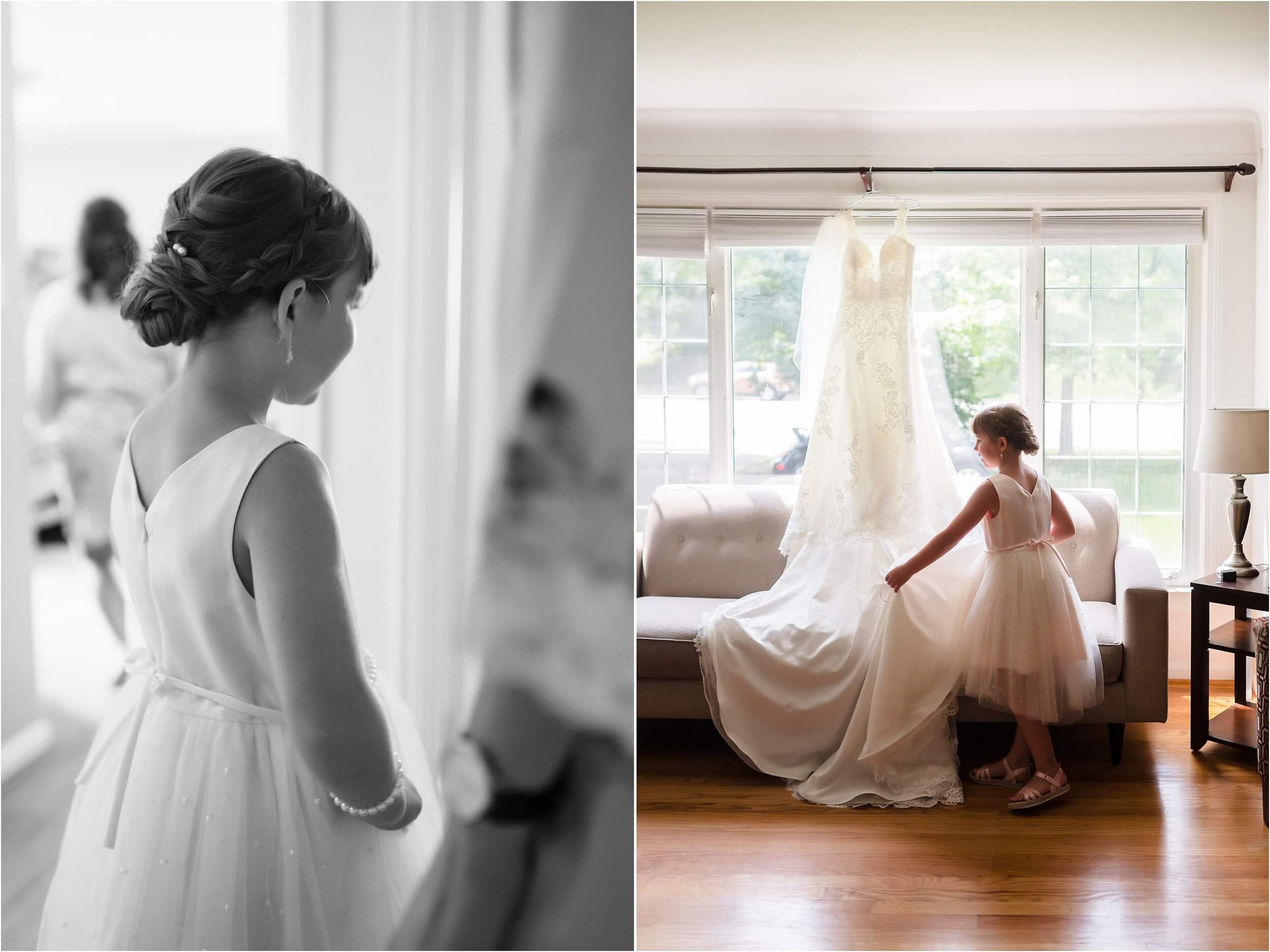  A flower girl fluffs a wedding dress hanging in a window.  