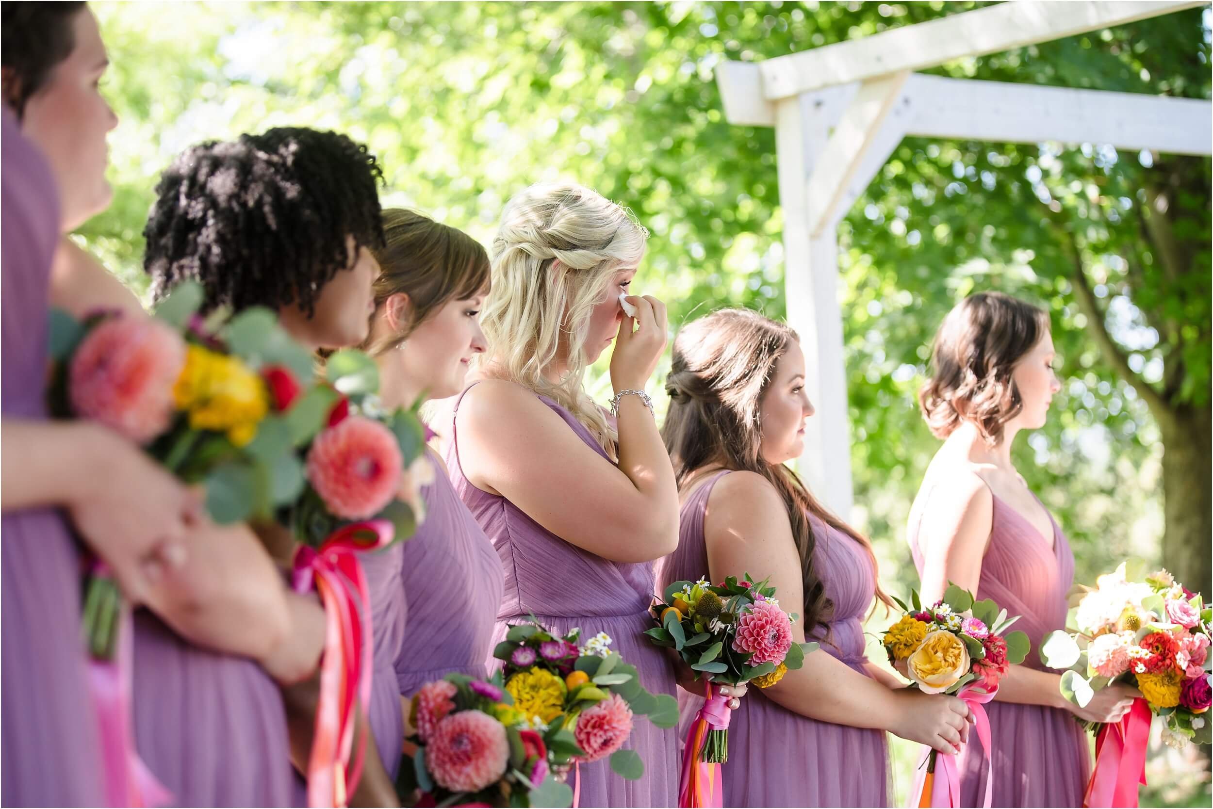 A bridesmaid dabs her eyes during her friends’ wedding ceremony.  