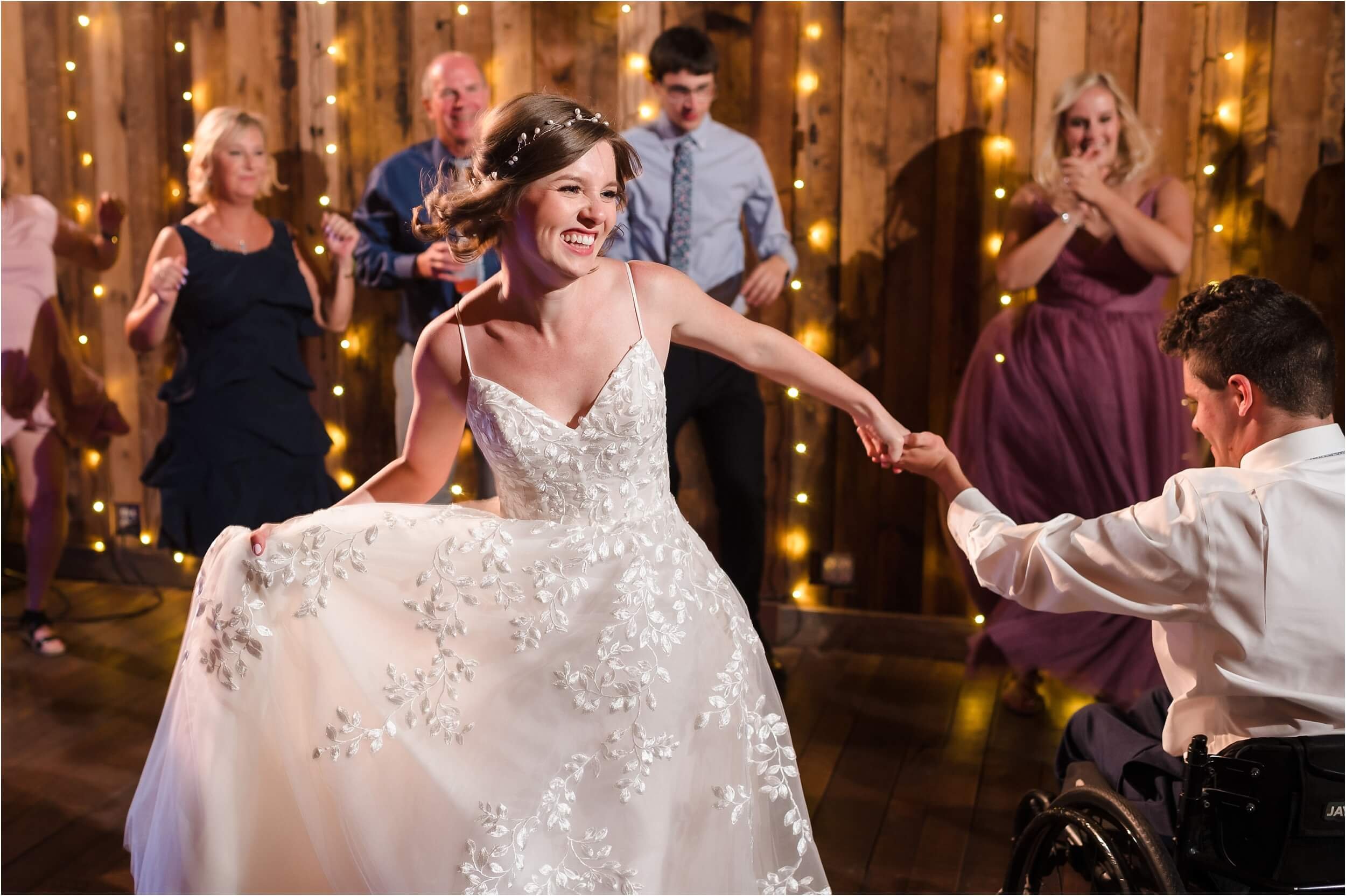  A bride dances with her brother at a wedding reception.  