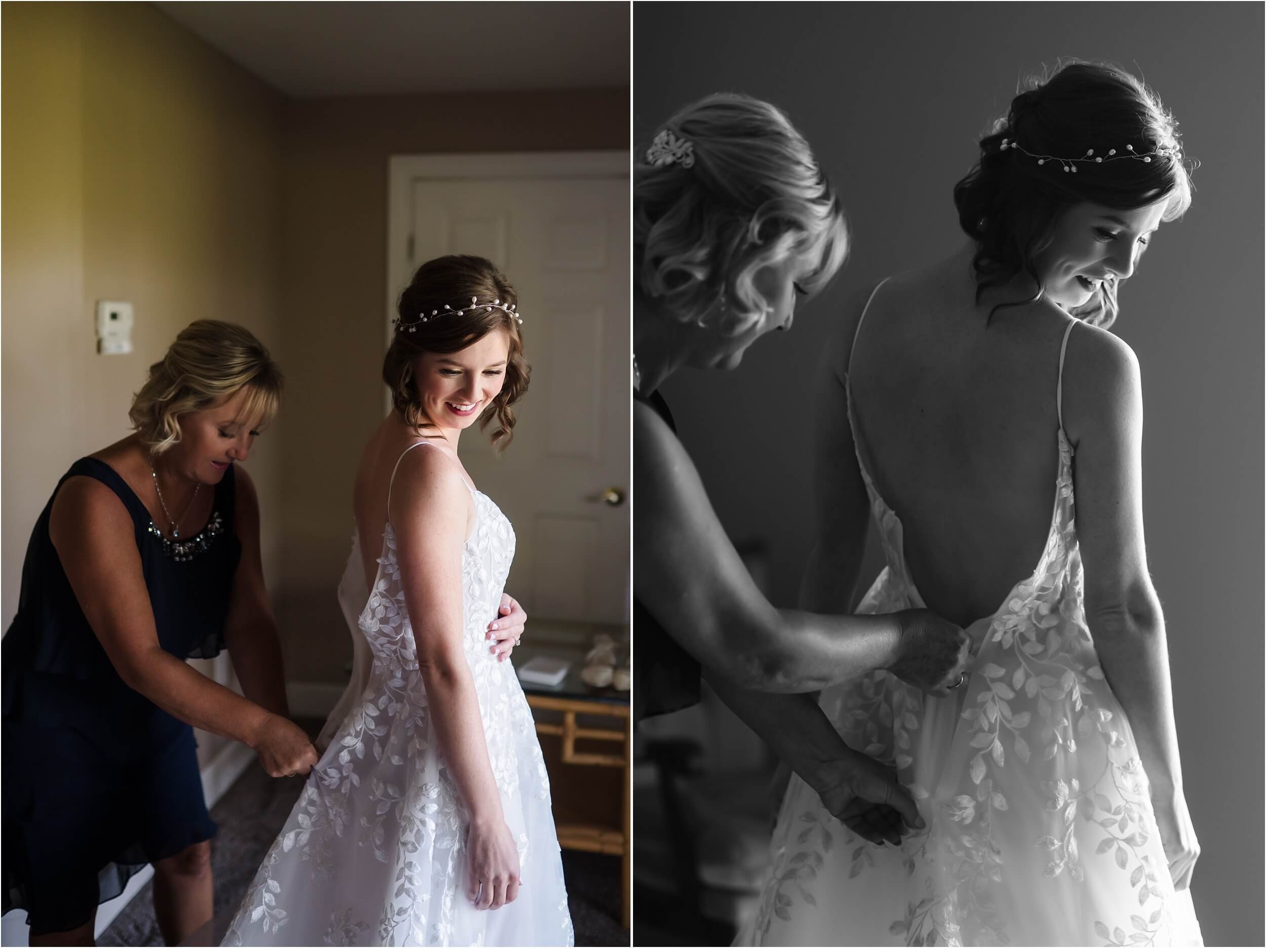 A mom helps her daughter zip up her white wedding dress.  