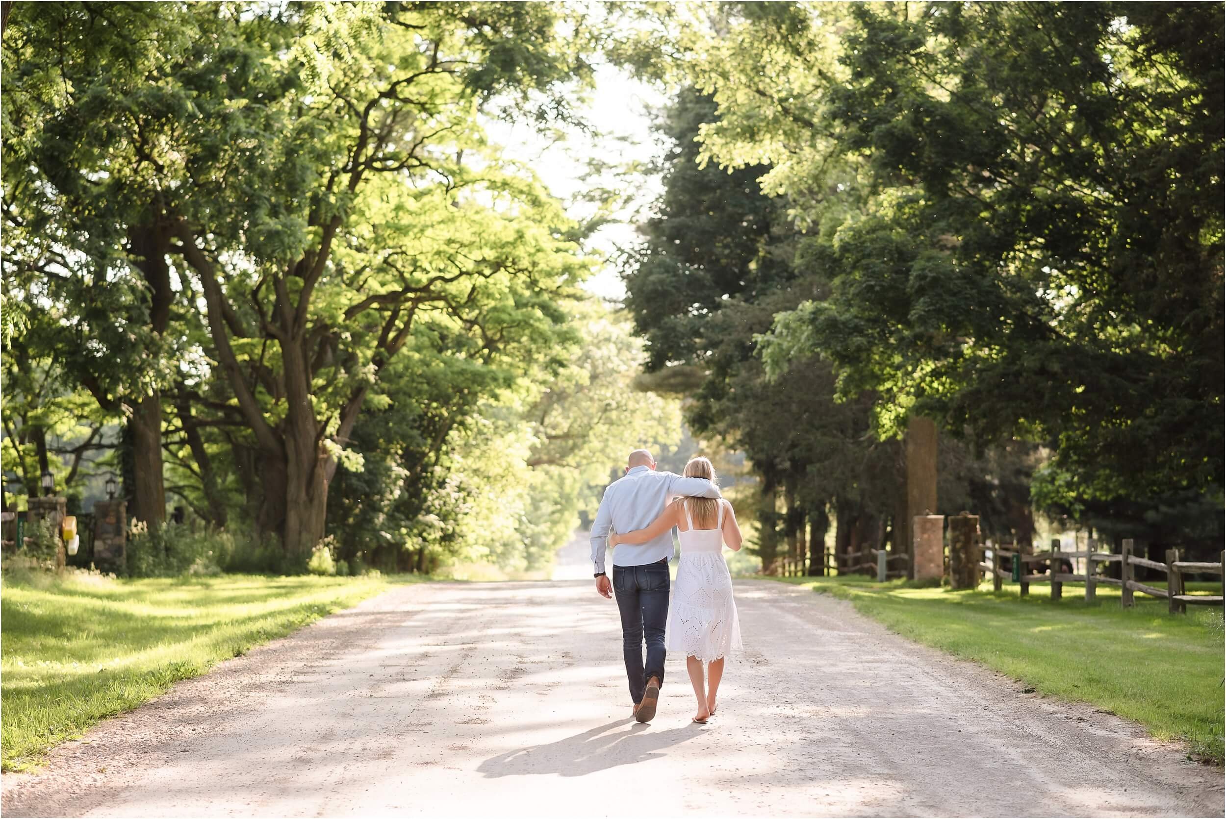  A couple walks away from the camera during their portrait session.  