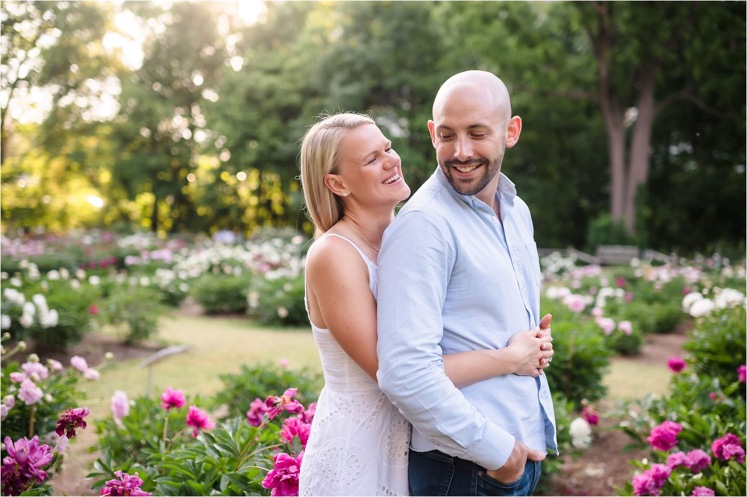  A bride sneaks up behind her soon-to-be husband during their engagement session.  