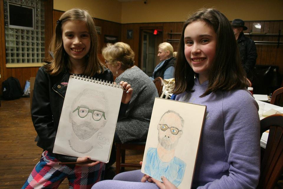  Penny and Tillie Averre showing off their drawings of Alan Glazen at Sachsenheim Hall.  12-14-18 