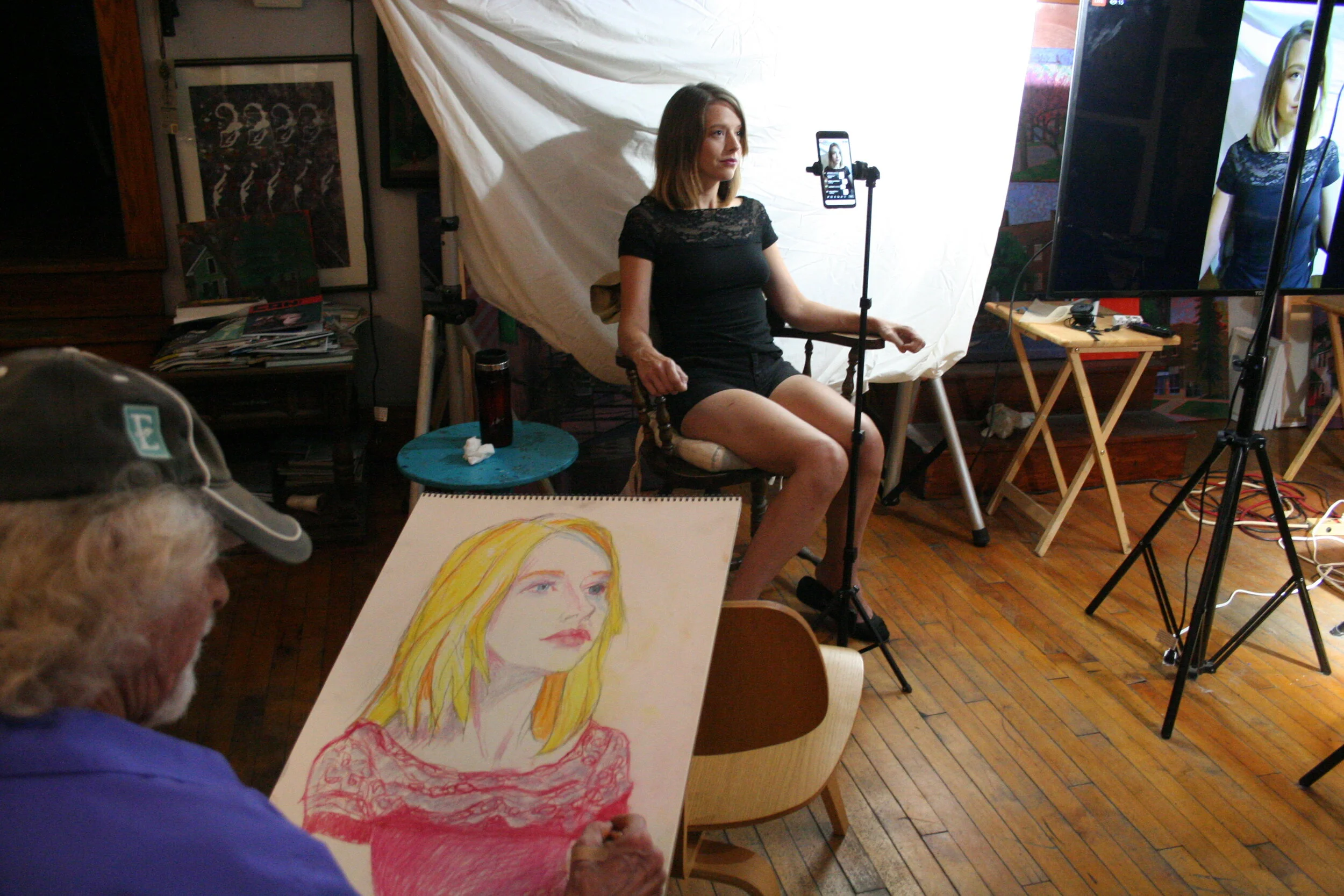 Larry Zuzik drawing Chelsea. photo by Brian Pierce