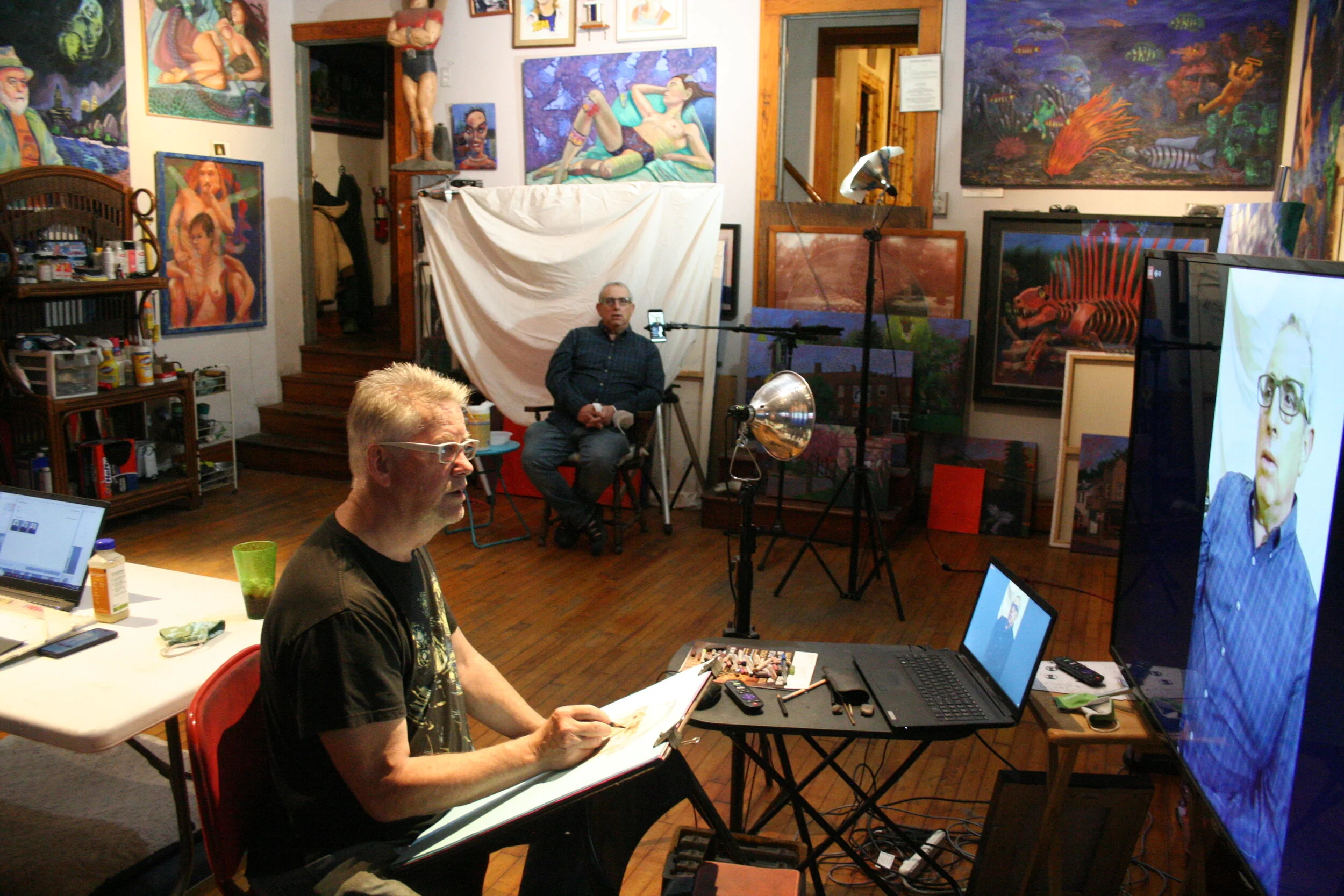 Timothy drawing Larry. Photo by Brian Pierce