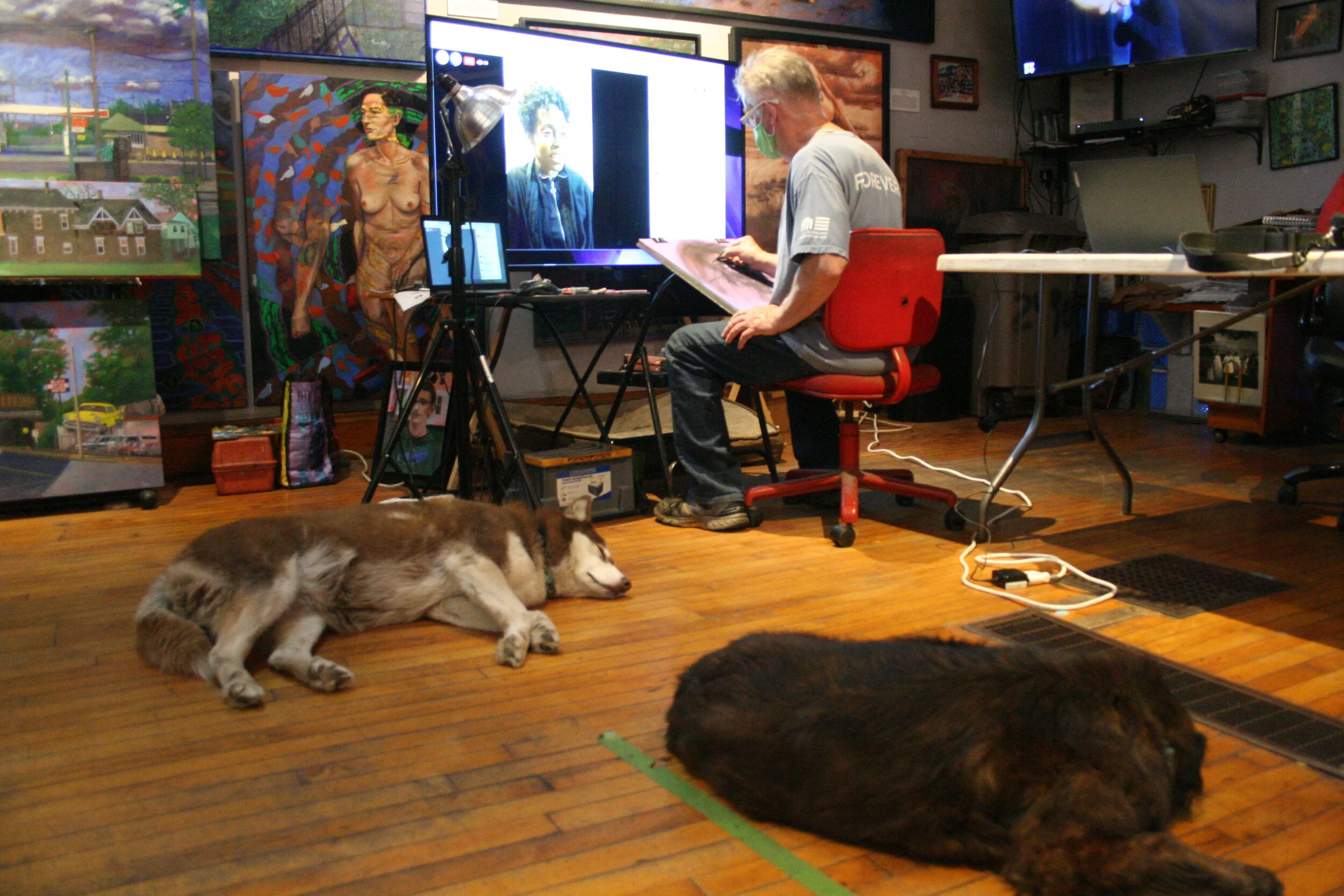 Timothy Herron drawing while Telia poses nearby. Photo by Brian Pierce