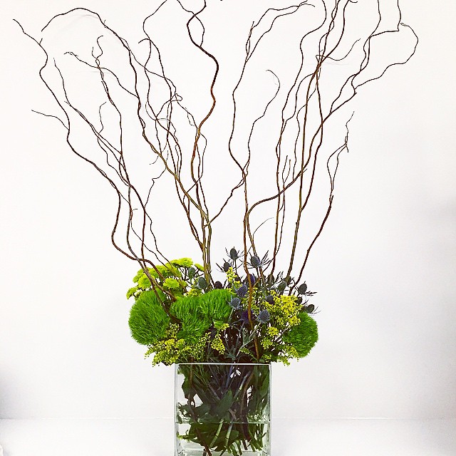 @interfaceamericas is having an event today and #mrsdovebelly provided all of the floral...here is just one of the many! #floral #interface #design #arrangement #event #flowers #branches #green #yellow #purple #client