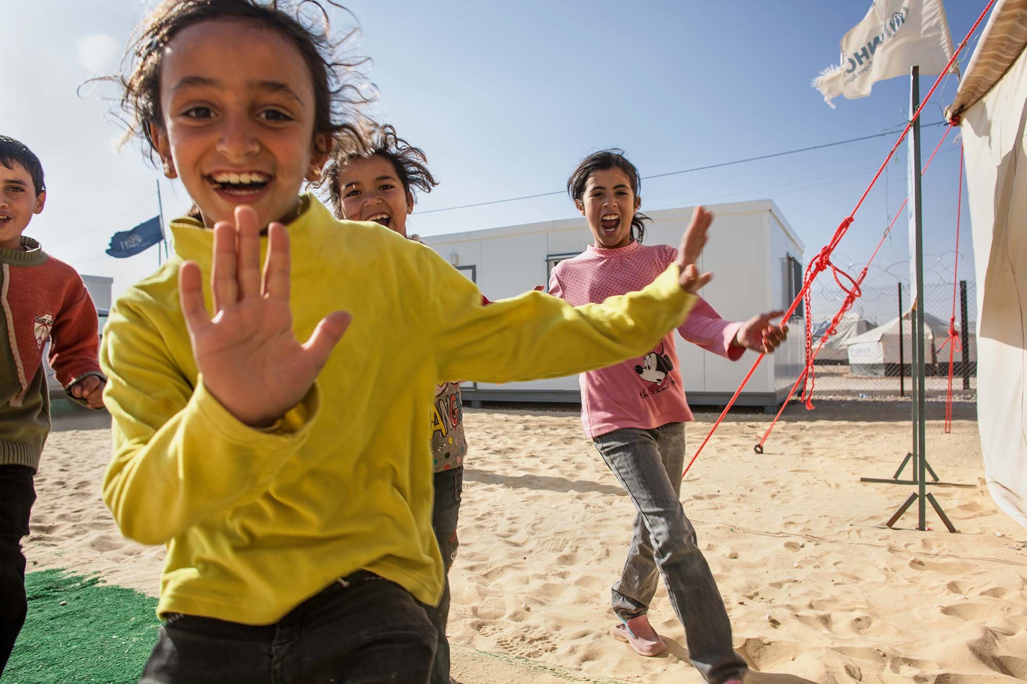  Children at Zaatari rush to enter a UNHCR tent where a Clowns Without Borders Ireland show is about to commence.&nbsp; 